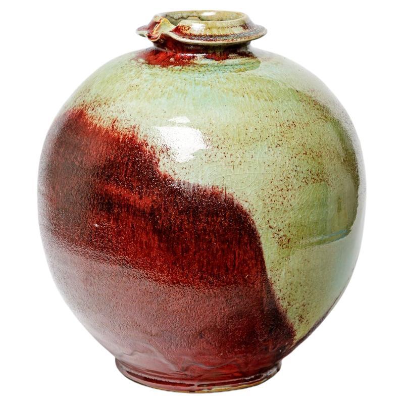 Red glazed ceramic vase by Michel Lanos