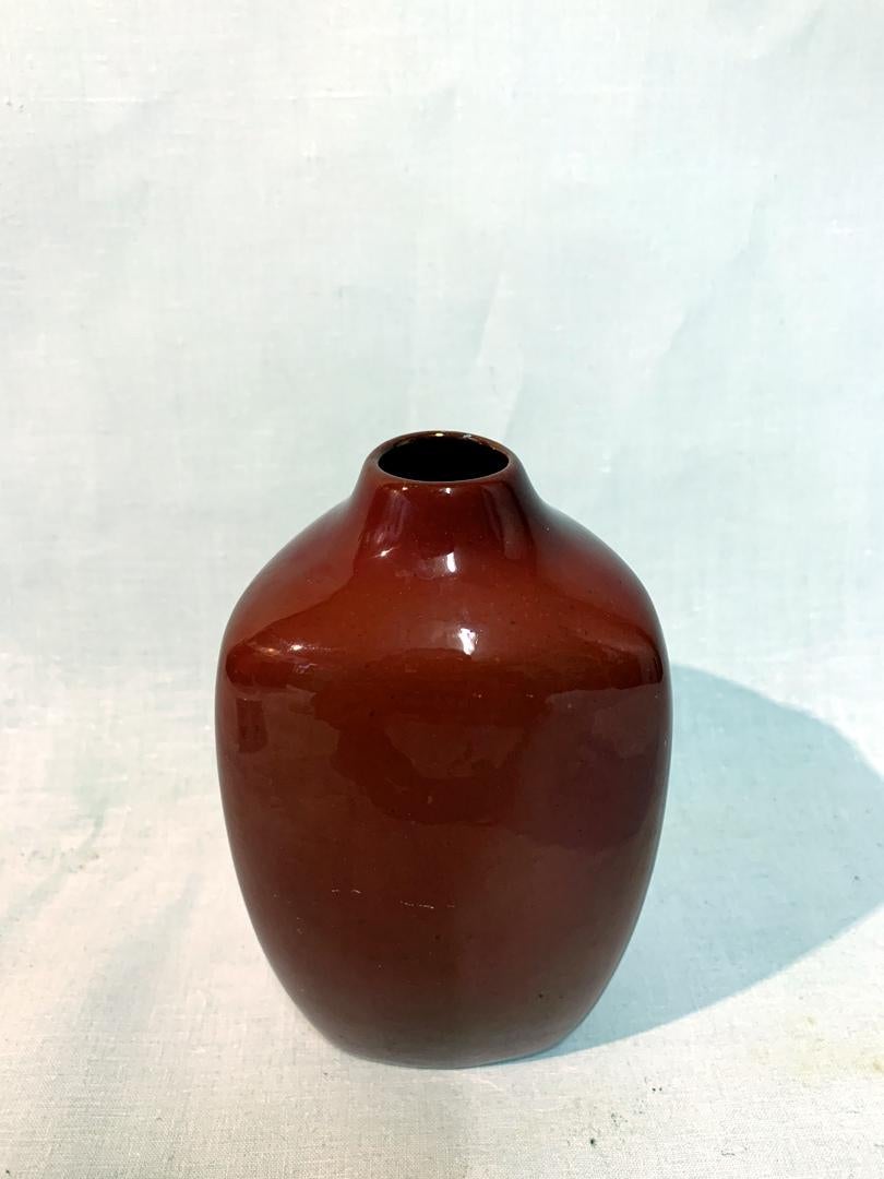 This vase was designed by artist Janos Török, designer for the Zsolnay factory and is glazed a special red glaze developed by Zsolnay. The 1960s design piece is in great condition. 

About Zsolnay: The history of the Zsolnay Factory started in