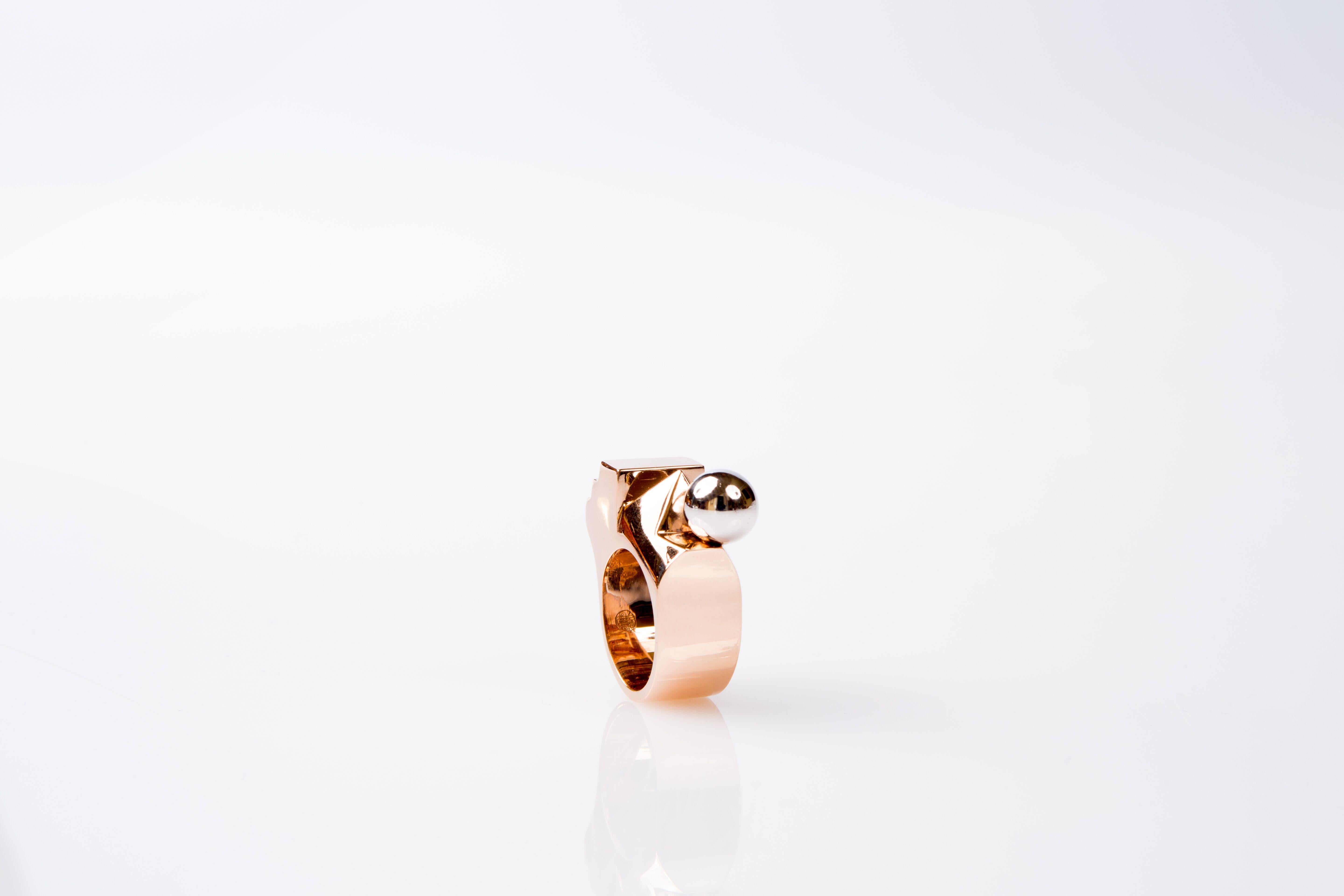 Very original exclusive piece of our collection.

We have handcrafted this modern and architectural ring with red gold 18K featuring a Rhodium ball on the top, leaving a perfect finish to its original style.

Our creator has design this ring to