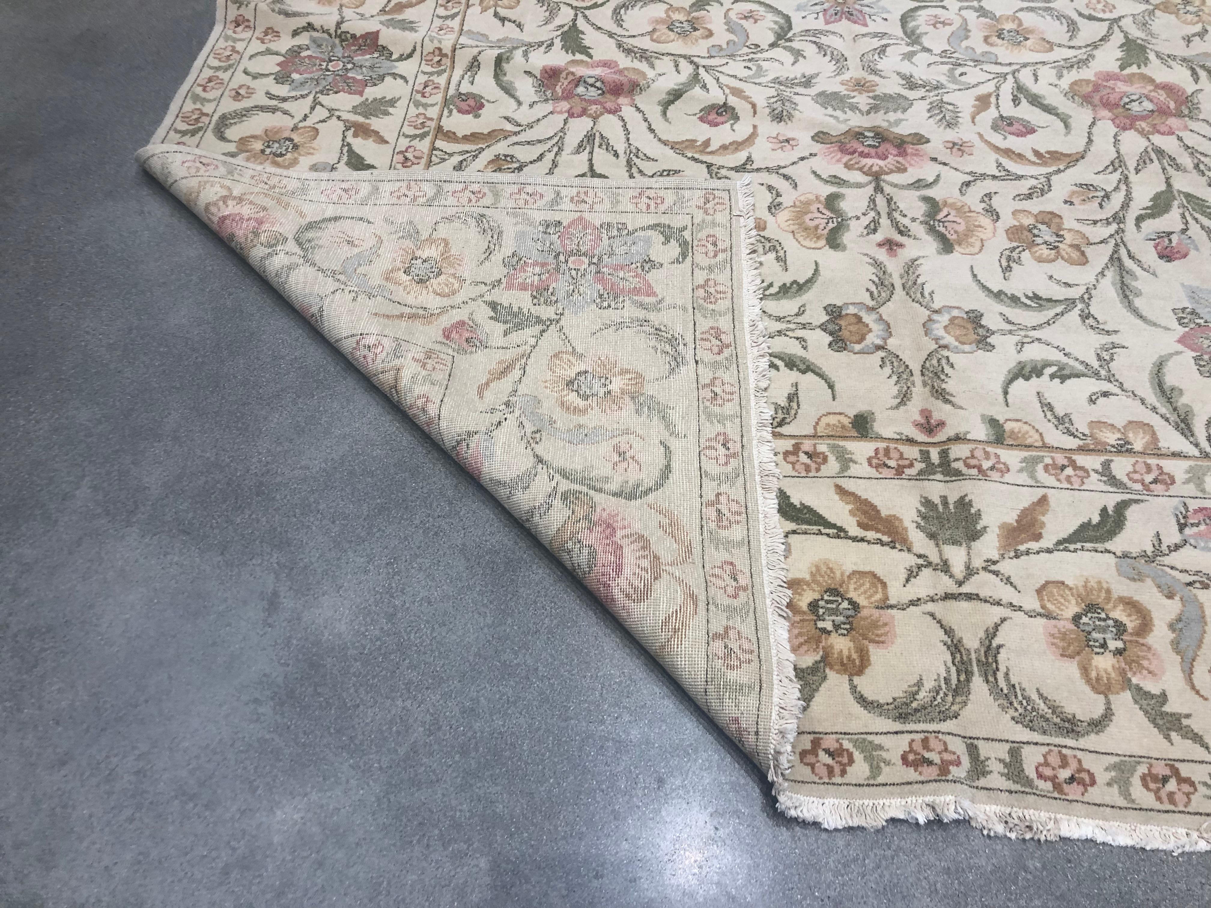 Un bouquet de rouge, d'or, d'argent et de vert prend vie dans ce tapis floral élégant et de bon goût. La toile de fond beige offre un canevas neutre sur lequel se détache la beauté simple des couleurs.