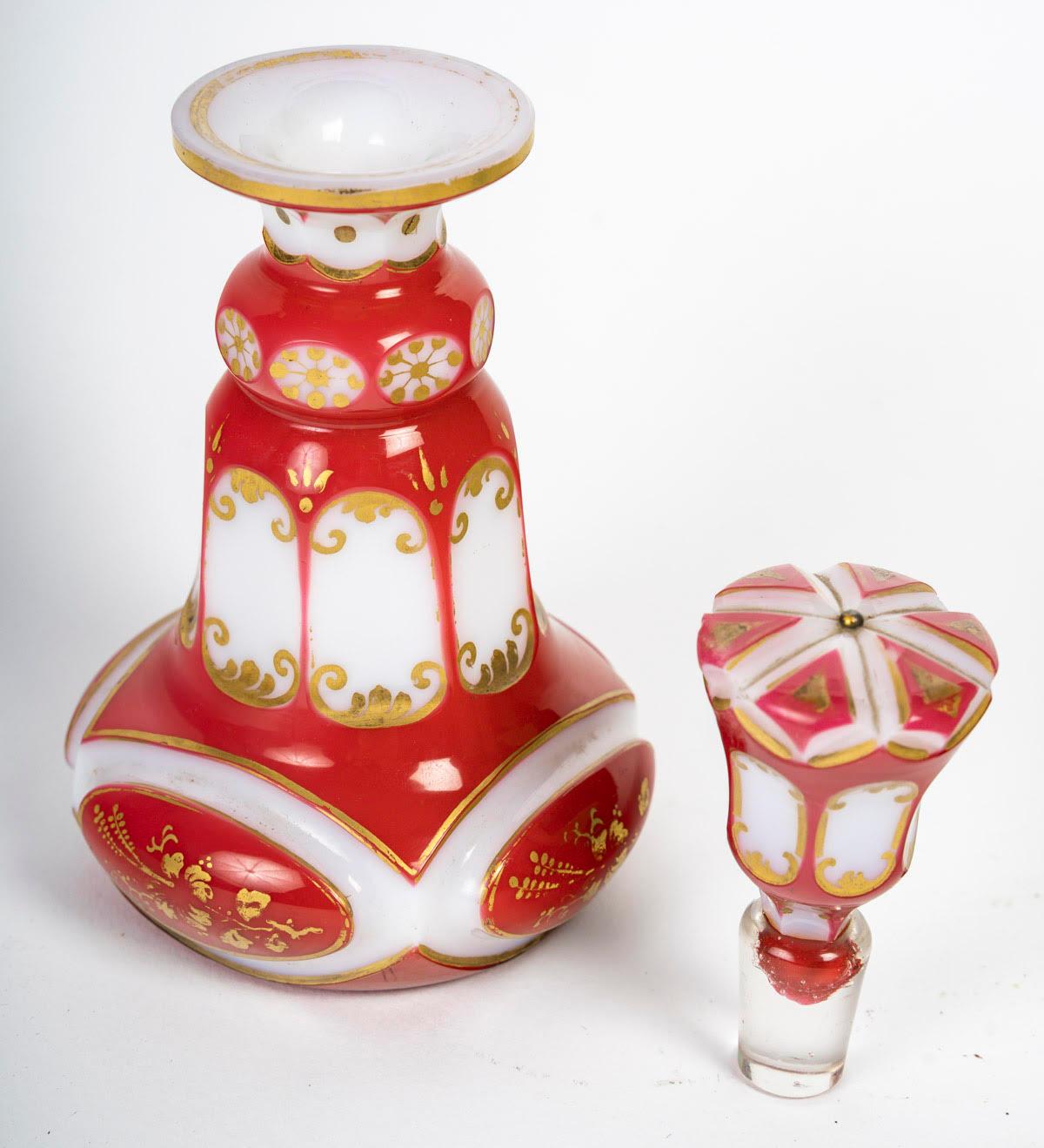 Red, gold and white opaline overlay bottle, 19th century, Napoleon III period.

Bottle in red, gold and white opaline overlay, 19th century, Napoleon III period.
H: 17cm D: 9cm