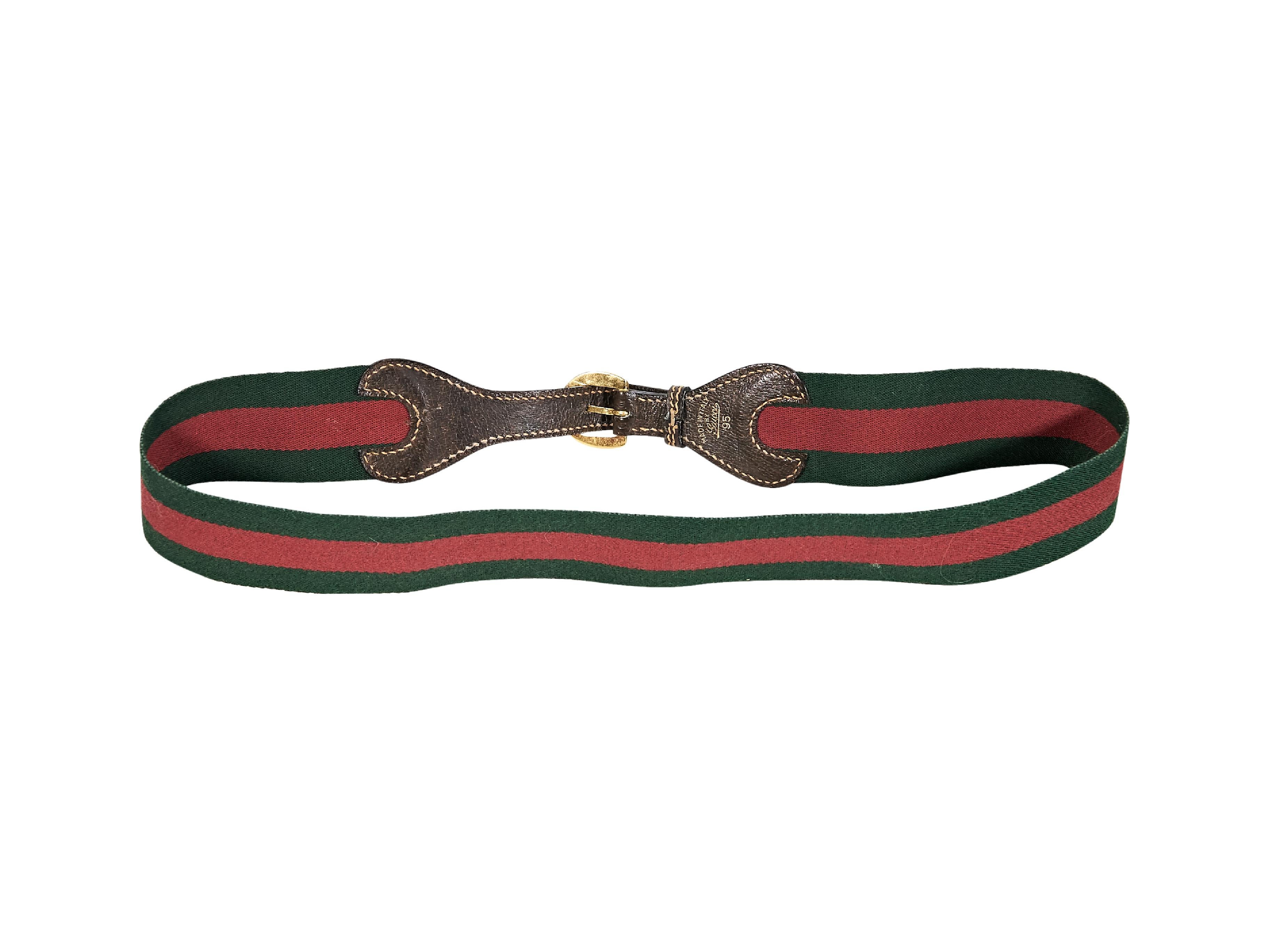 Product details:  Vintage red and green striped canvas belt by Gucci.  Trimmed with leather.  Adjustable buckle closure.  Goldtone hardware.  38-39