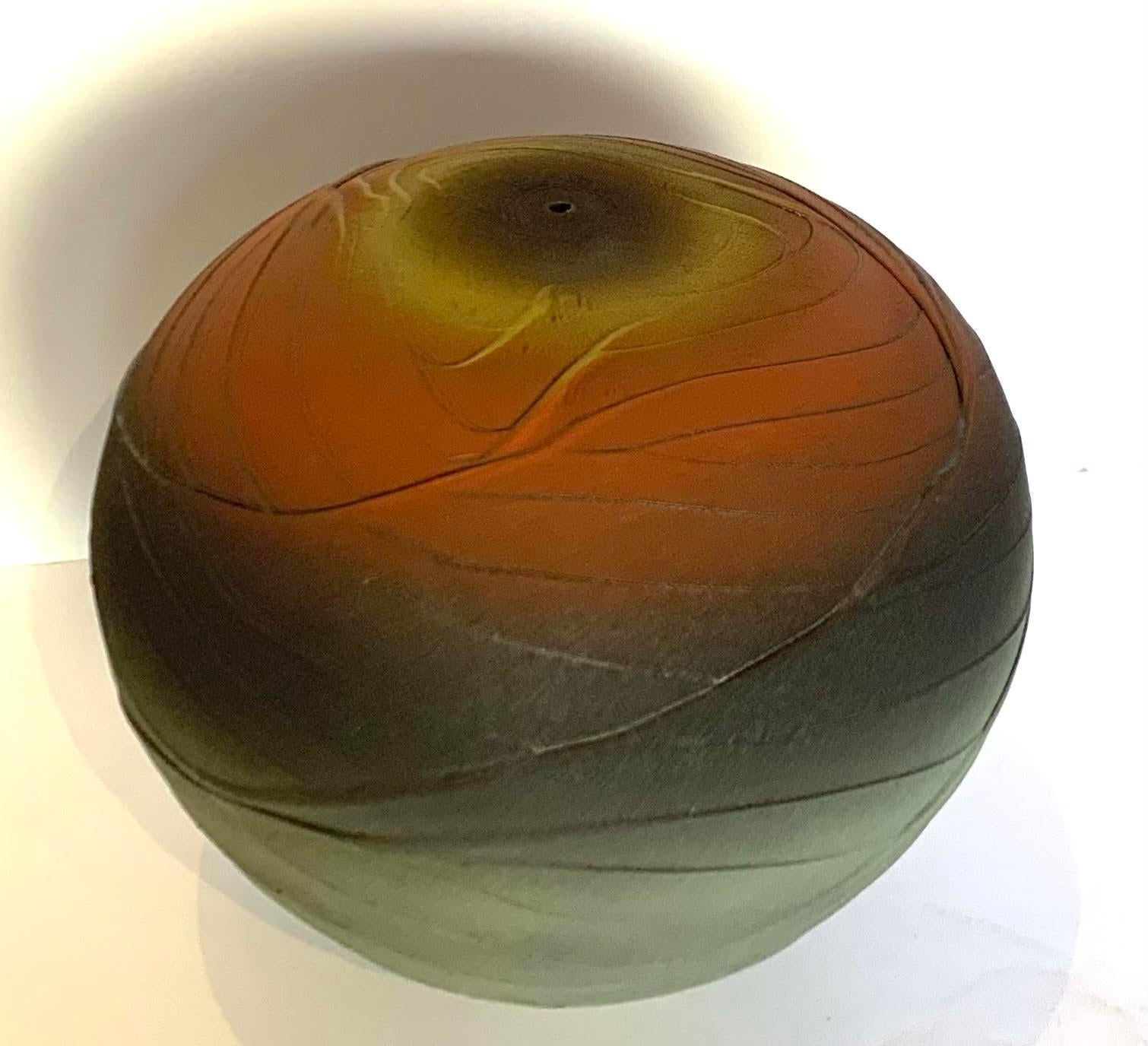 Contemporary textured ceramic earthenware vase.
Bands of brick red, grey and green blend into each other.
The glaze has a crackle effect giving it an ancient feel.
Tiny top spout.
Hand made one of a kind.
Part of a collection of earthenware