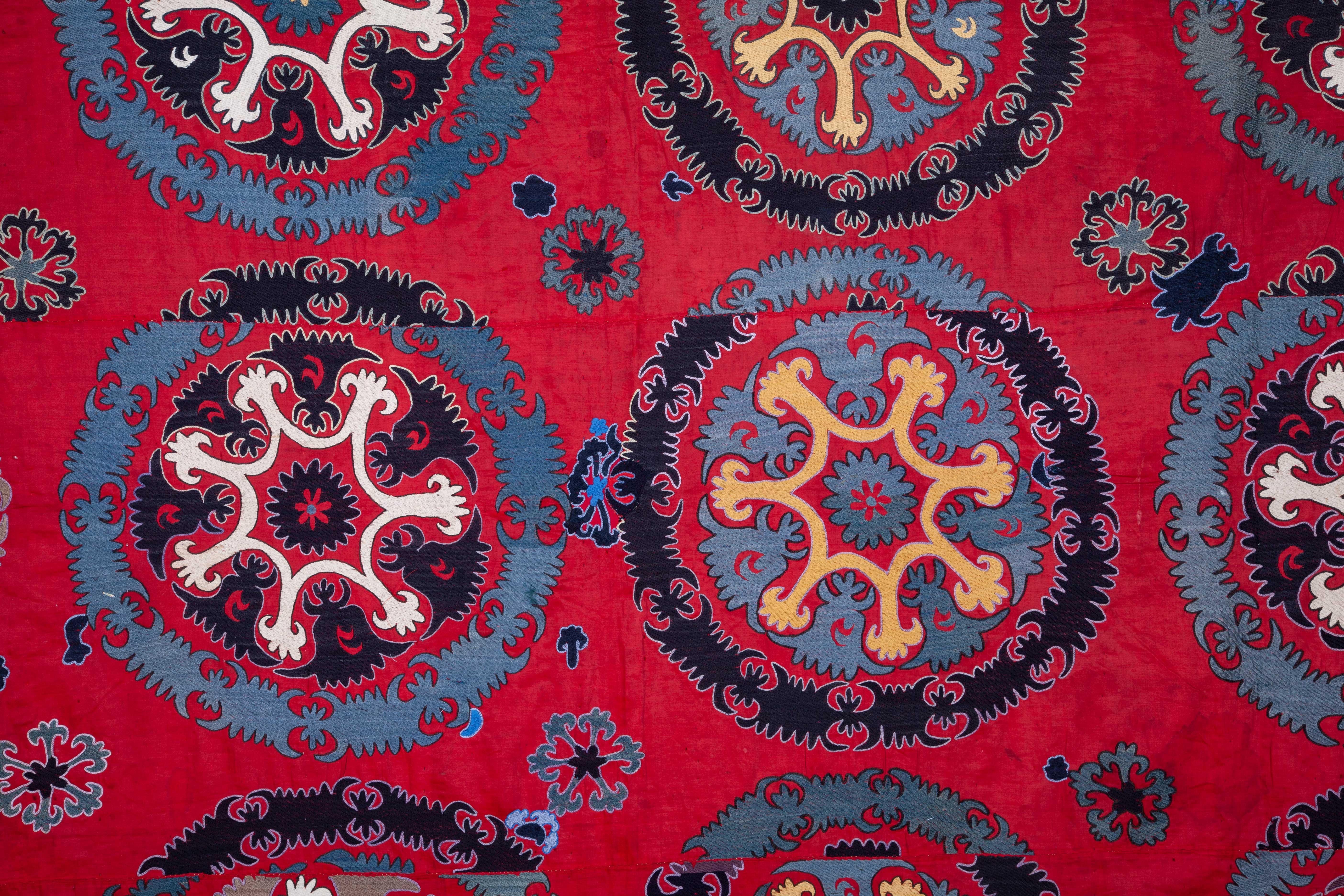 A finely embroidered rare type of Suzani with a patchwork of lining from Russian prints.