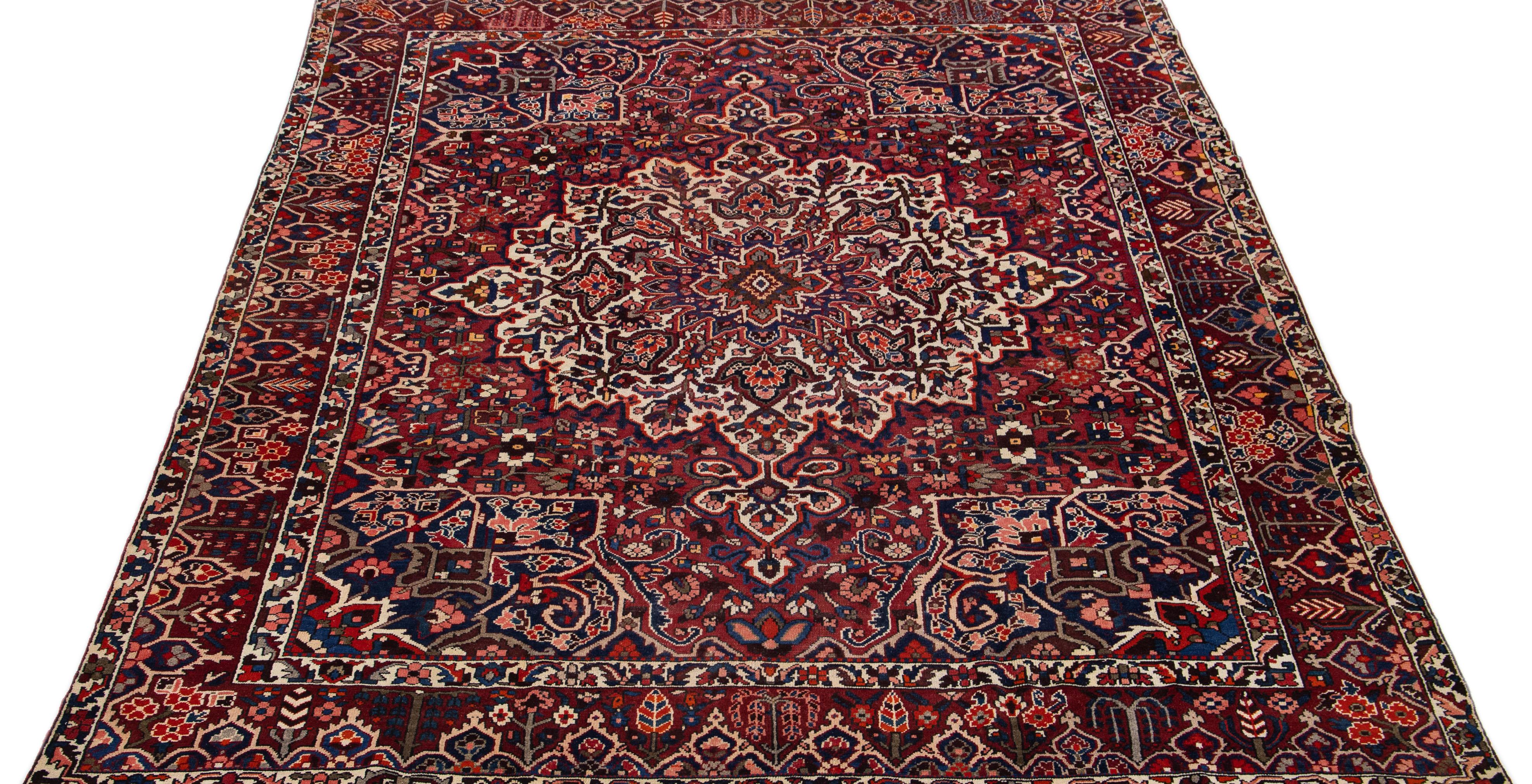 20th Century Red Handmade Antique Bakhtiari Persian Wool Rug with Medallion Motif For Sale