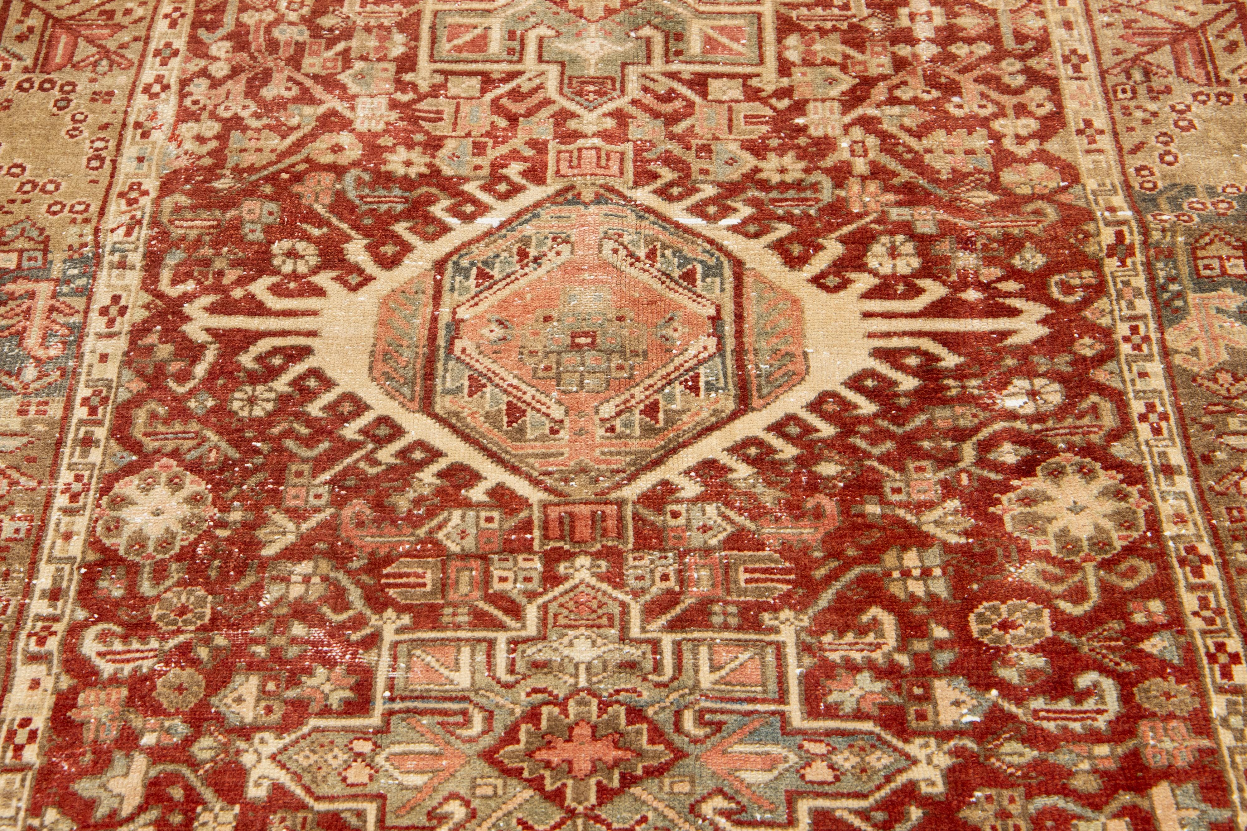 Early 20th Century Red Handmade Antique Wool Rug Persian Heriz Featuring a Medallion Motif  For Sale