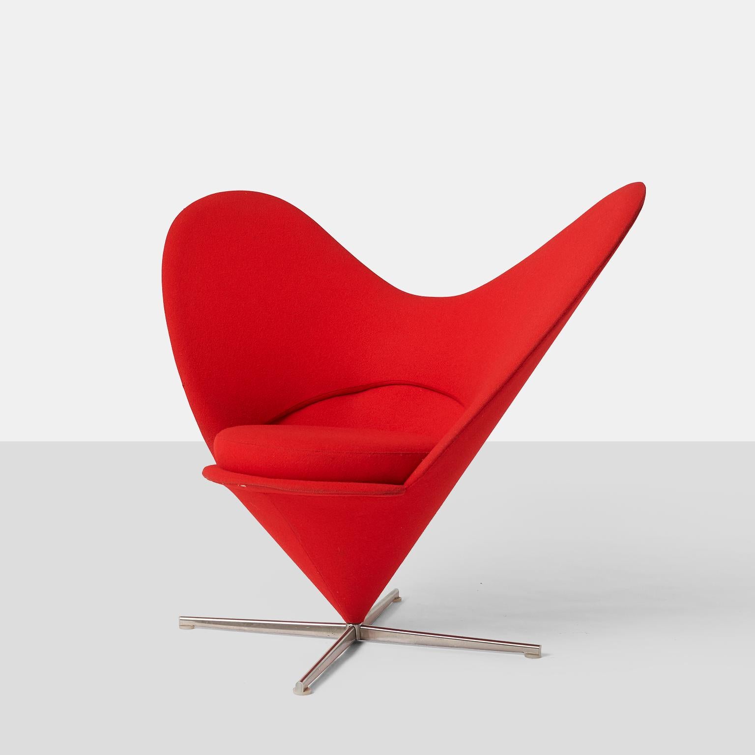 An iconic red heart cone chair by Vernor Panton. Designed in 1958, this chair was produced by Vitra in 2000. 

The fabric is in original condition with some signs of use. One chair has 2 small holes in the fabric along the seam.

Two available.