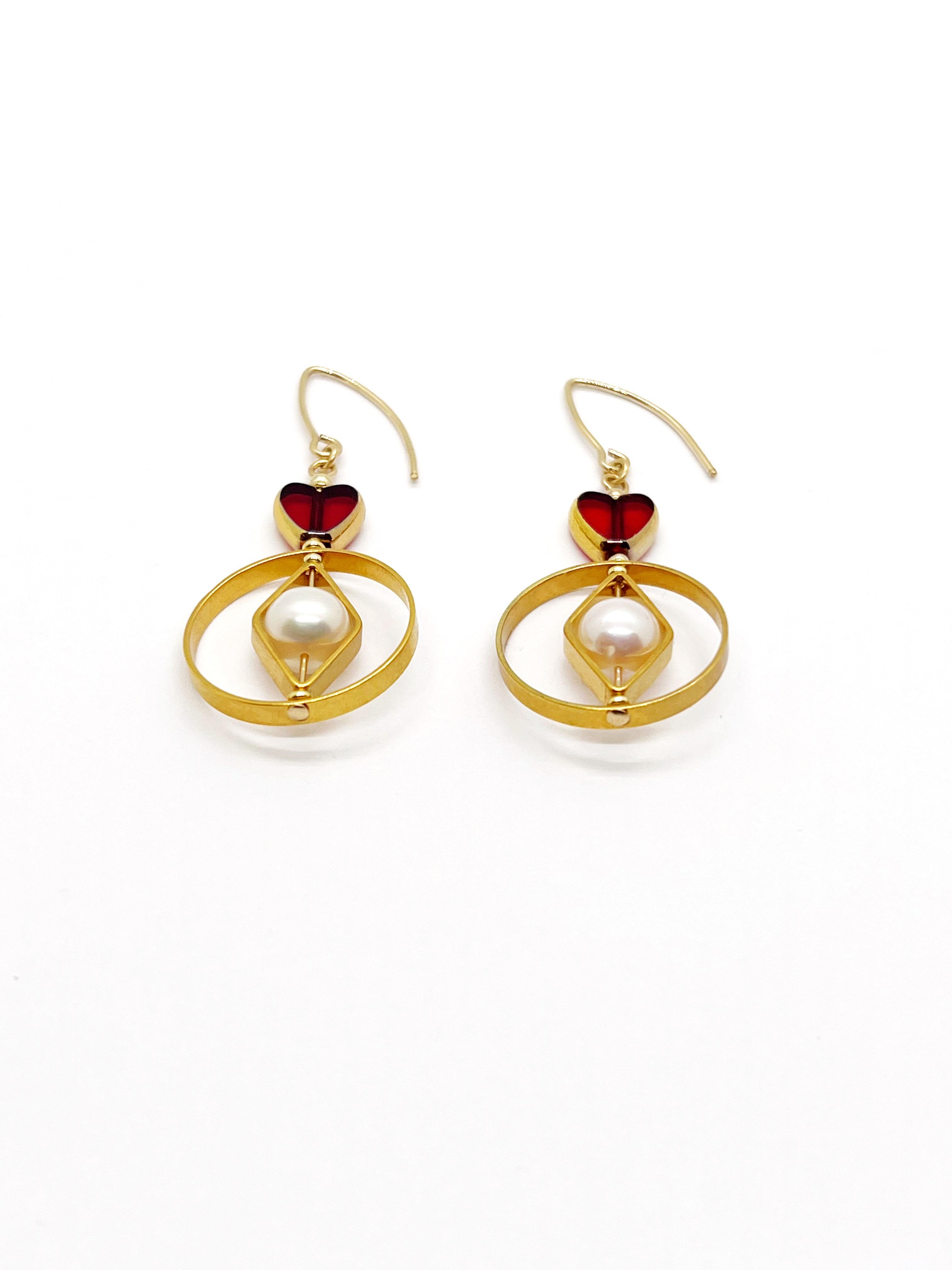 These earrings are light weight. It is composed of German Vintage Glass Beads that are edged with 24K gold. It is incorporated with oval freshwater pearls set in a 24K gold plated brass geometric frame.

The vintage glass beads that is framed with