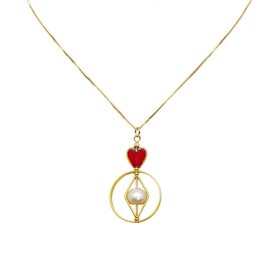 The necklace is composed of German Vintage Glass Beads that are edged with 24K gold. It is incorporated with oval freshwater pearls set in a geometric frame with an 18 inch gold-fill.

The vintage glass beads that is framed with 24K gold were hand