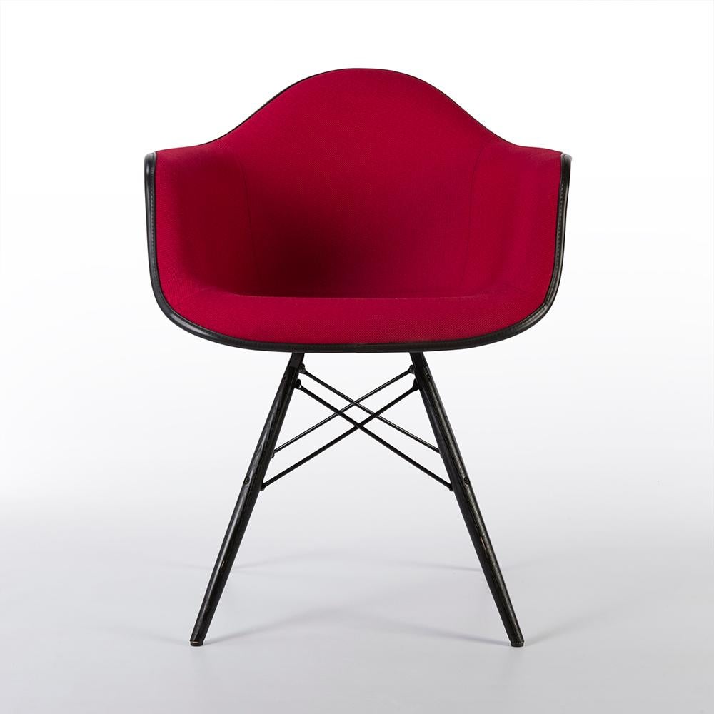 A great example of a newer all original Eames upholstered Herman Miller DAW dining arm chair finished in a vibrant red fabric finish which looks sumptuous on the black arm shell. Being a newer example, the condition is very good.