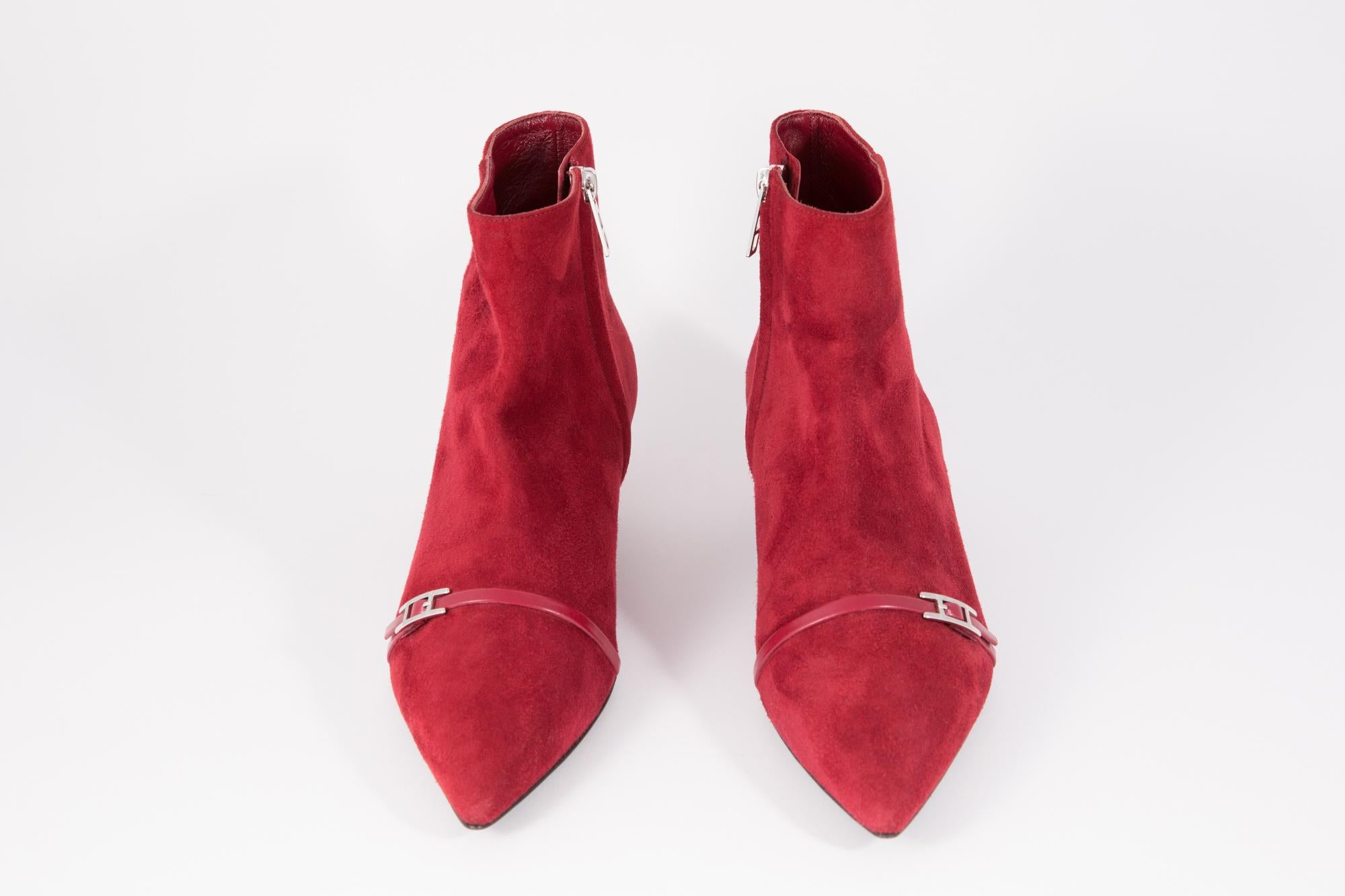 Deep red Hermes suede leather boots featuring  a front silver tone H buckle, a side silver tone logo zipper. a short length, a thin heel 1.5in. (4cm). Delivered in original dust bag.  
In Excellent vintage condition. 
Shoes Size: 36fr/ 5 US/ 2UK
We