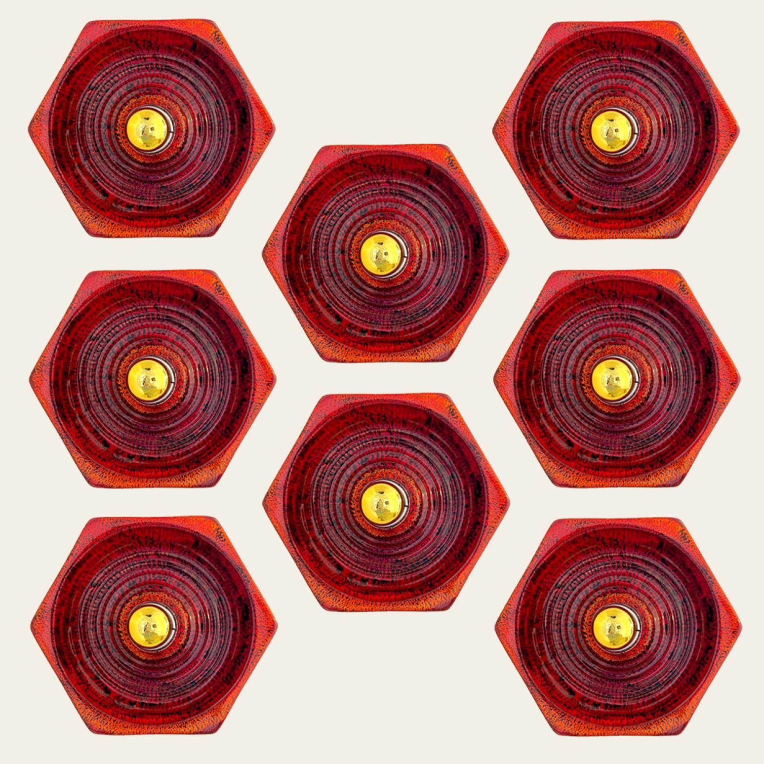 Eight hexagonal red ceramic wall lights. Manufactured by Hustadt Leuchten, Germany in the 1970s.
We used gold light bulbs (see images), but silver light bulbs are also very stylish.

Measurements:
Diameter: 11.81 in (30 cm)
Depth: 4.72 in (12