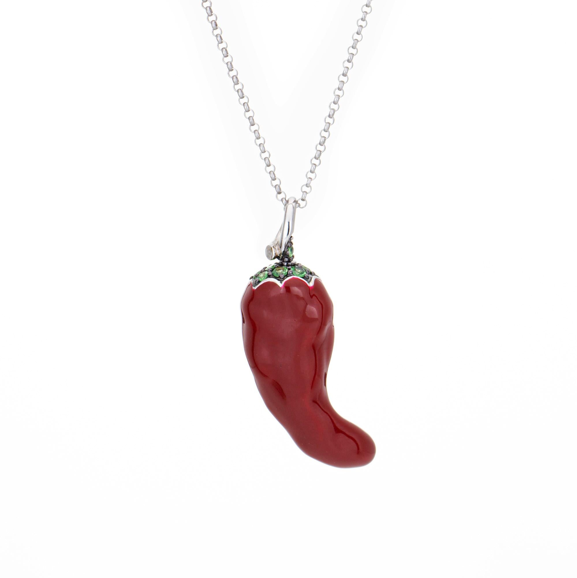 Charming red hot chili pepper pendant & necklace, crafted in 14 karat white gold. The chili features lifelike detail, rendered in red enamel with tsavorite garnets adorning the top of the chili and diamonds sprinkled inside the chili to depict the