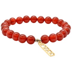 Red Jade Bead Bracelet with 14 Karat Yellow Gold Love Charm