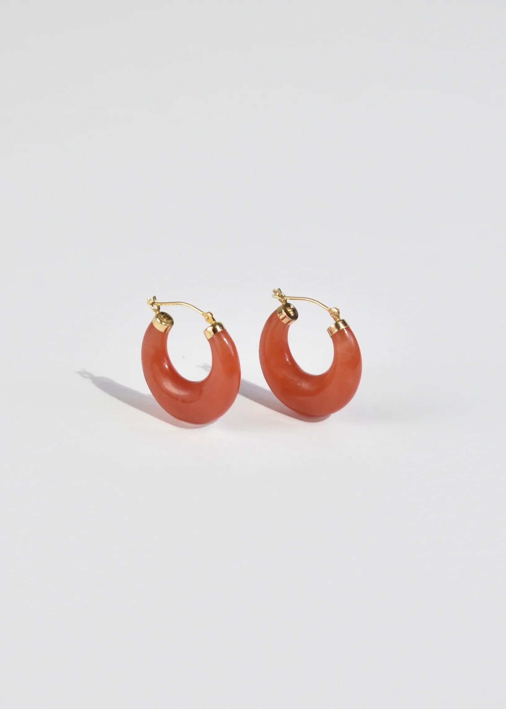 Stunning carved red jade hoop earrings with gold detail, pierced. Stamped 14k.

Material: 14k gold, jade.

We recommend storing in a dry place and periodic polishing with a cloth.