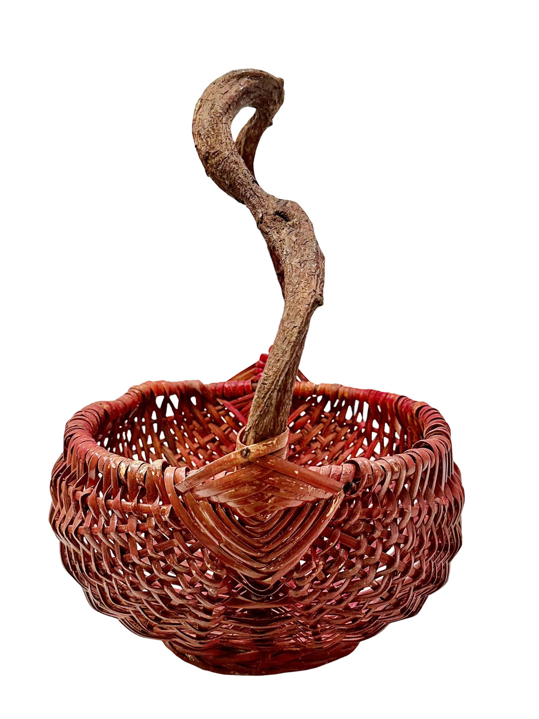 A vintage Japanese basket with a wooden handle and a wonderful red patina. Circa early 20th century, Japan. 
