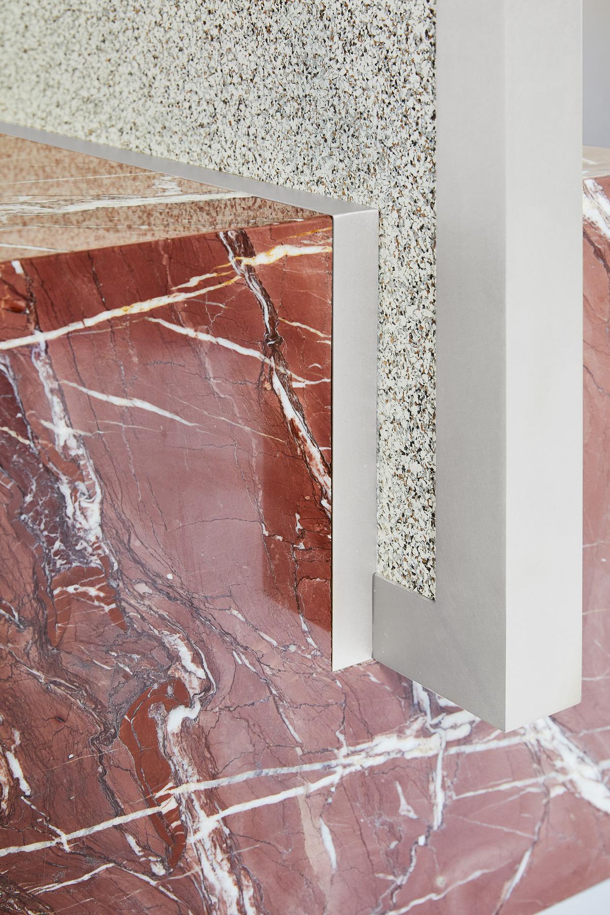 The coexist standing mirror consists of a red jasper marble cube base, brushed nickel frame, and recycled rubber backing.

The framed mirror fits into a rich veined marble cube base with precision. The piece is able to be assembled with no hardware