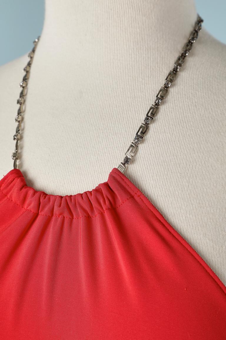 Backless Red jersey cocktail dress with metal and rhinestone chain.
84% polyamide, 16% elastane. 
SIZE 44It/ 40 Fr / M 