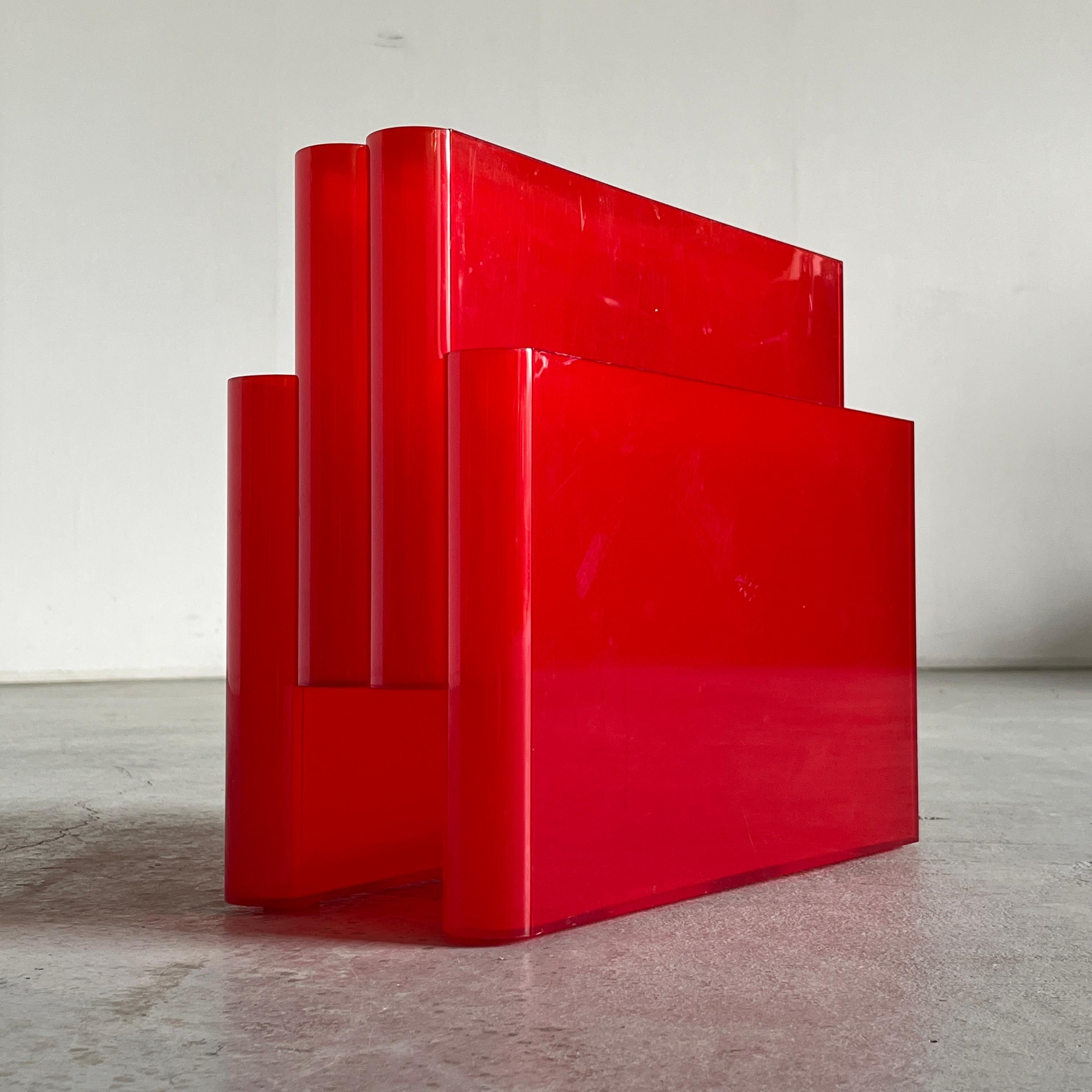 The iconic space age magazine rack designed by Giotto Stoppino for Kartell in 1972.
Model no. 4676, made of clear red ABS plastic and features four compartments and an integrated handle.
Made in Italy, c. 1970s.

In very good vintage condition with