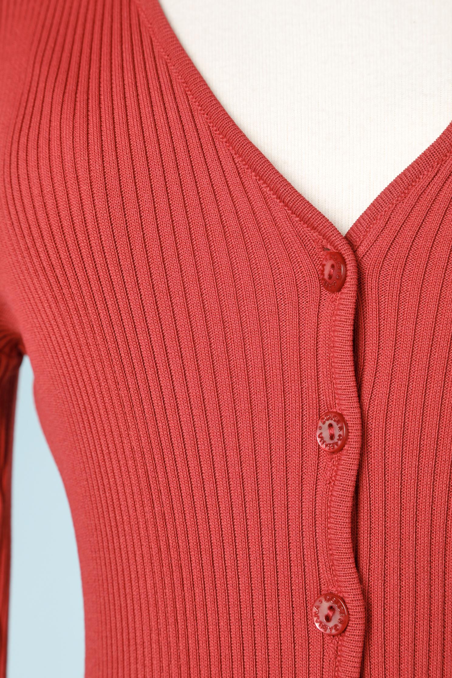 Red knit cardigan with branded buttons.
SIZE M