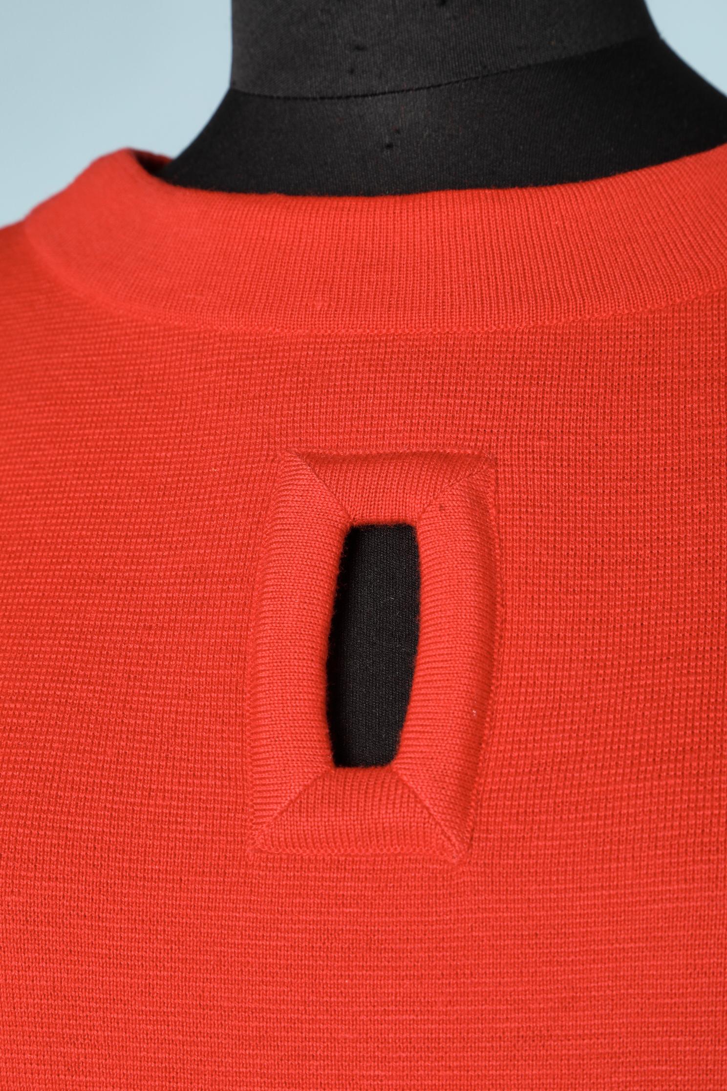 Red knit wool sleeveless dress. Zip in the middle back. Opening in the middle front and decorative pockets. No lining. 
SIZE L