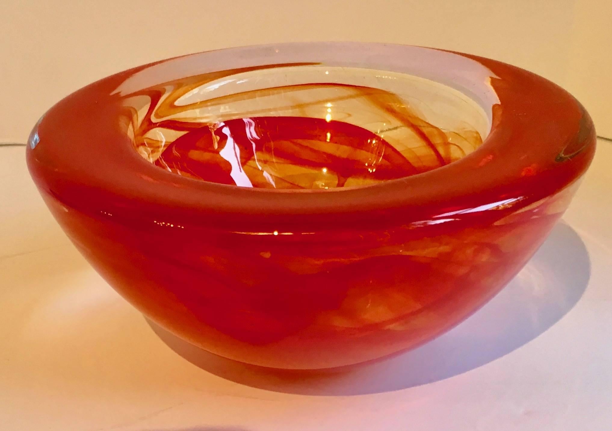 Red Kosta Boda Bowl by Anna Ehrner - a beautiful bowl (we also have the smaller companion bowl in same material) 
Great for anything, from nuts, to cotton balls to paper clips - a great piece for the desk or vanity or bar.