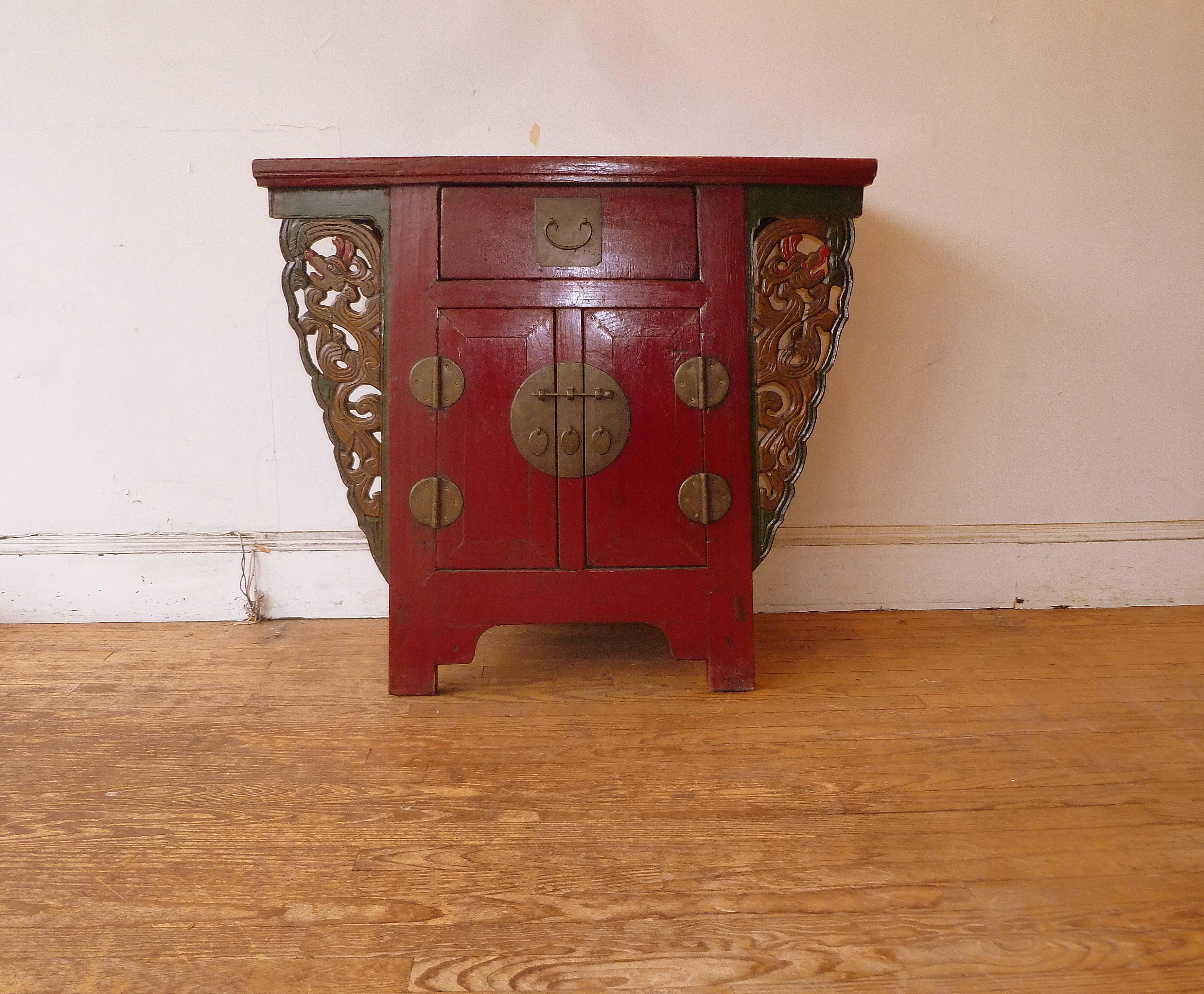 Red lacquer altar coffer with carved stylize dragons spandrels.