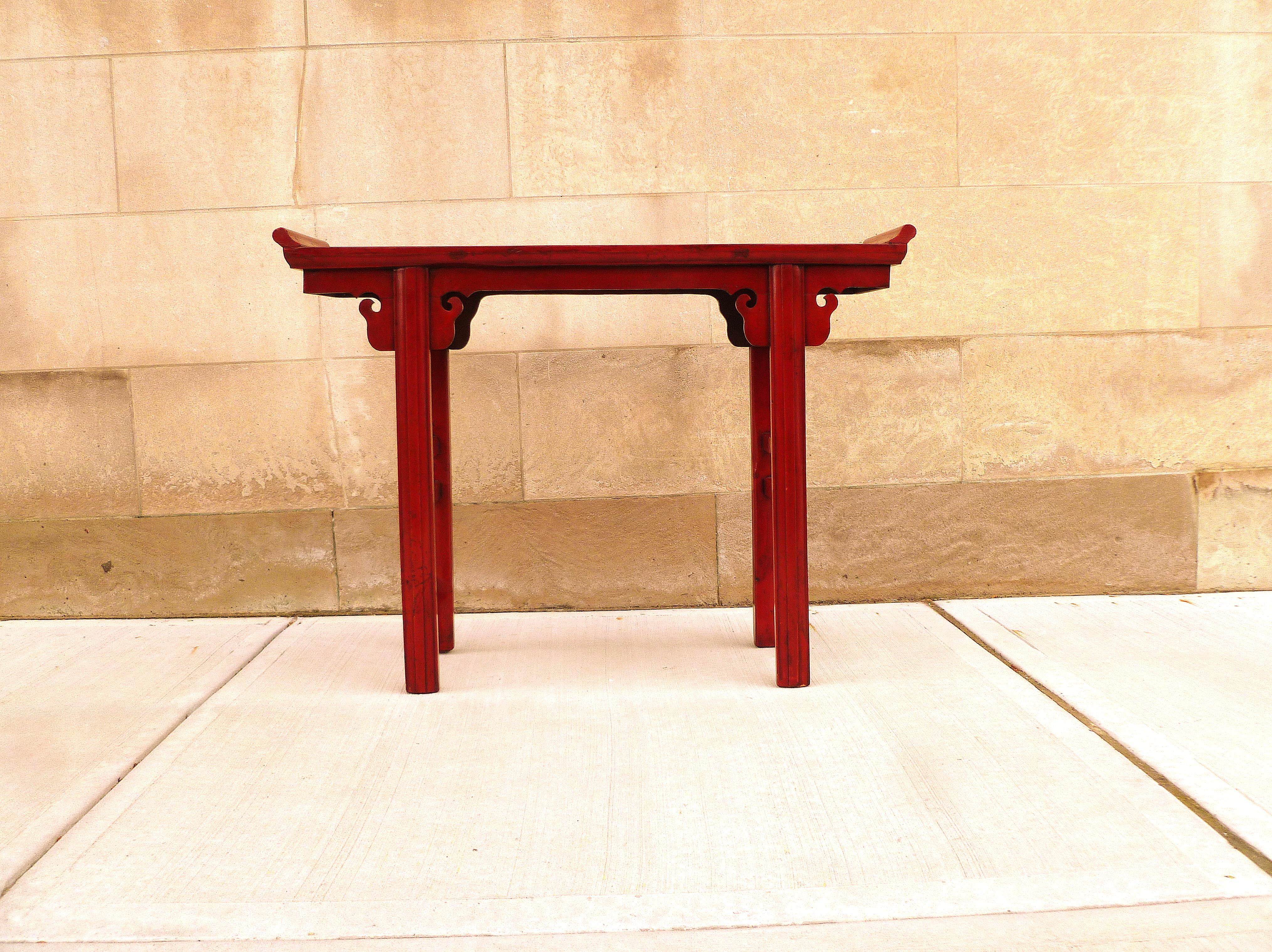 Red lacquer altar table with everted flangers.