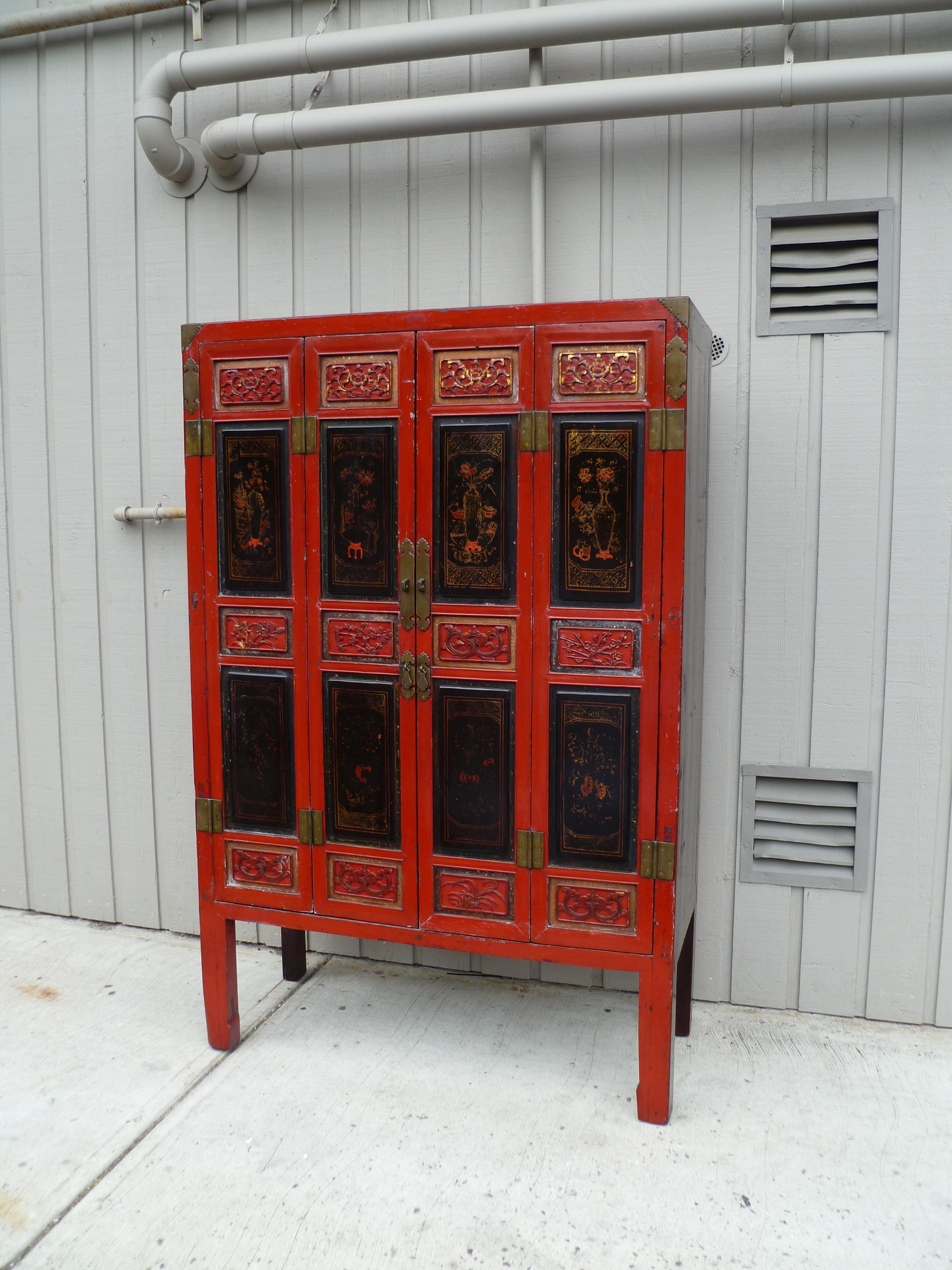 Chinese Red Lacquer Armoire with Relief Carving & Gilt Motif For Sale