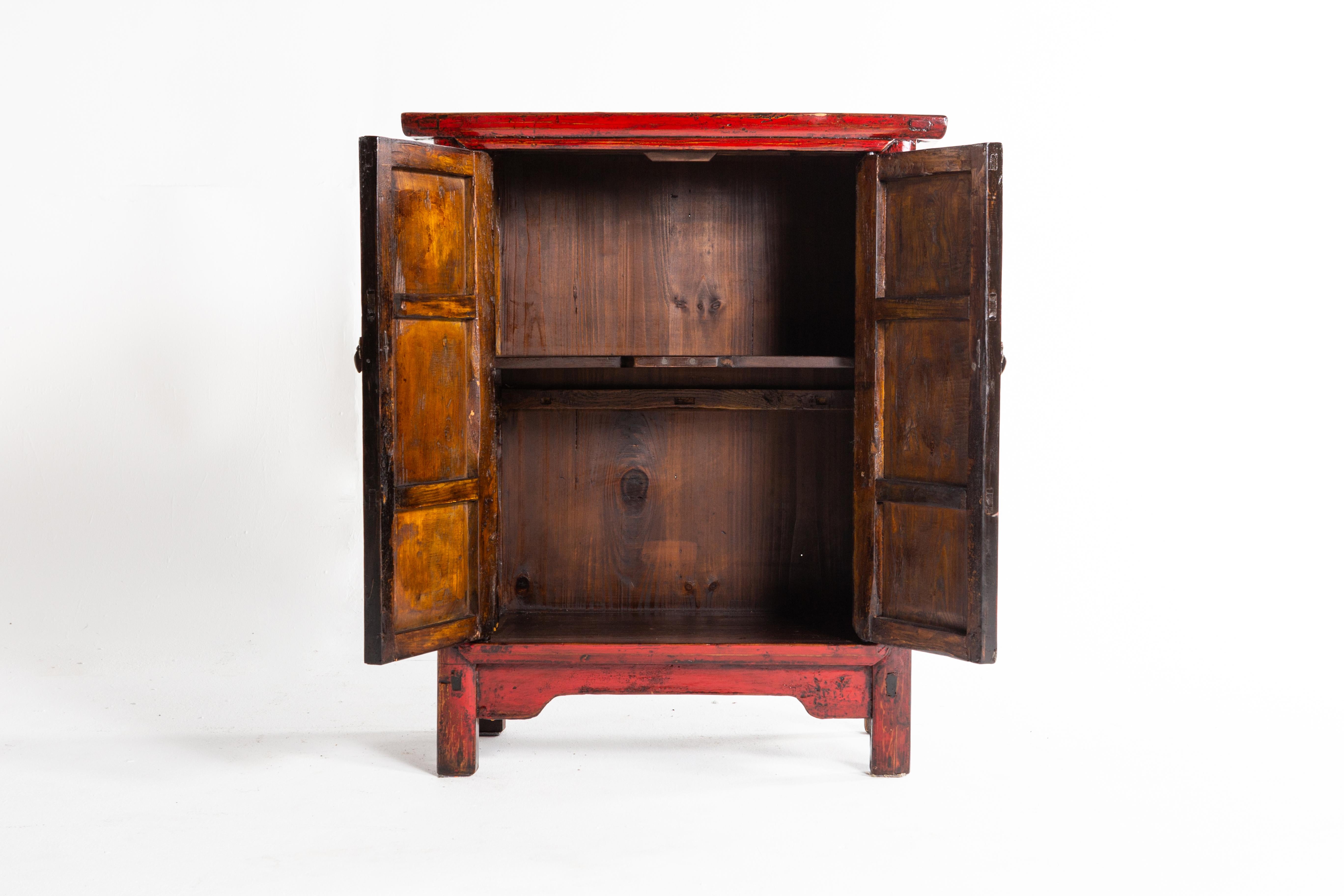 This red lacquer cabinet is from Shandong, China and was made from pine, elm, and lacquer, circa 1920. Wear consistent with age and use; the piece has been restored.