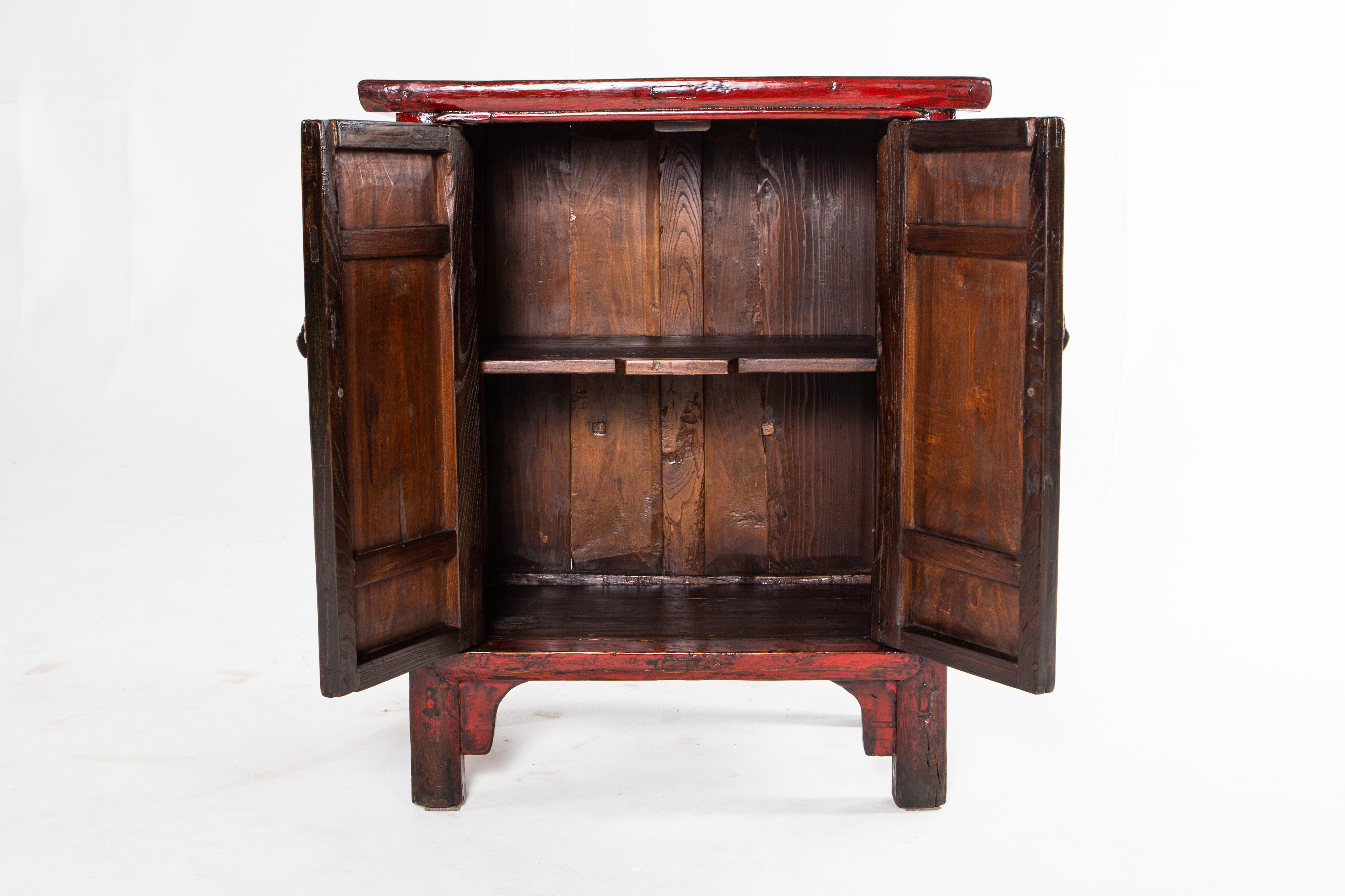 This red lacquer cabinet is from Shandong, China and was made from pine, elm, and lacquer, circa 1920. Wear consistent with age and use; the piece has been restored.