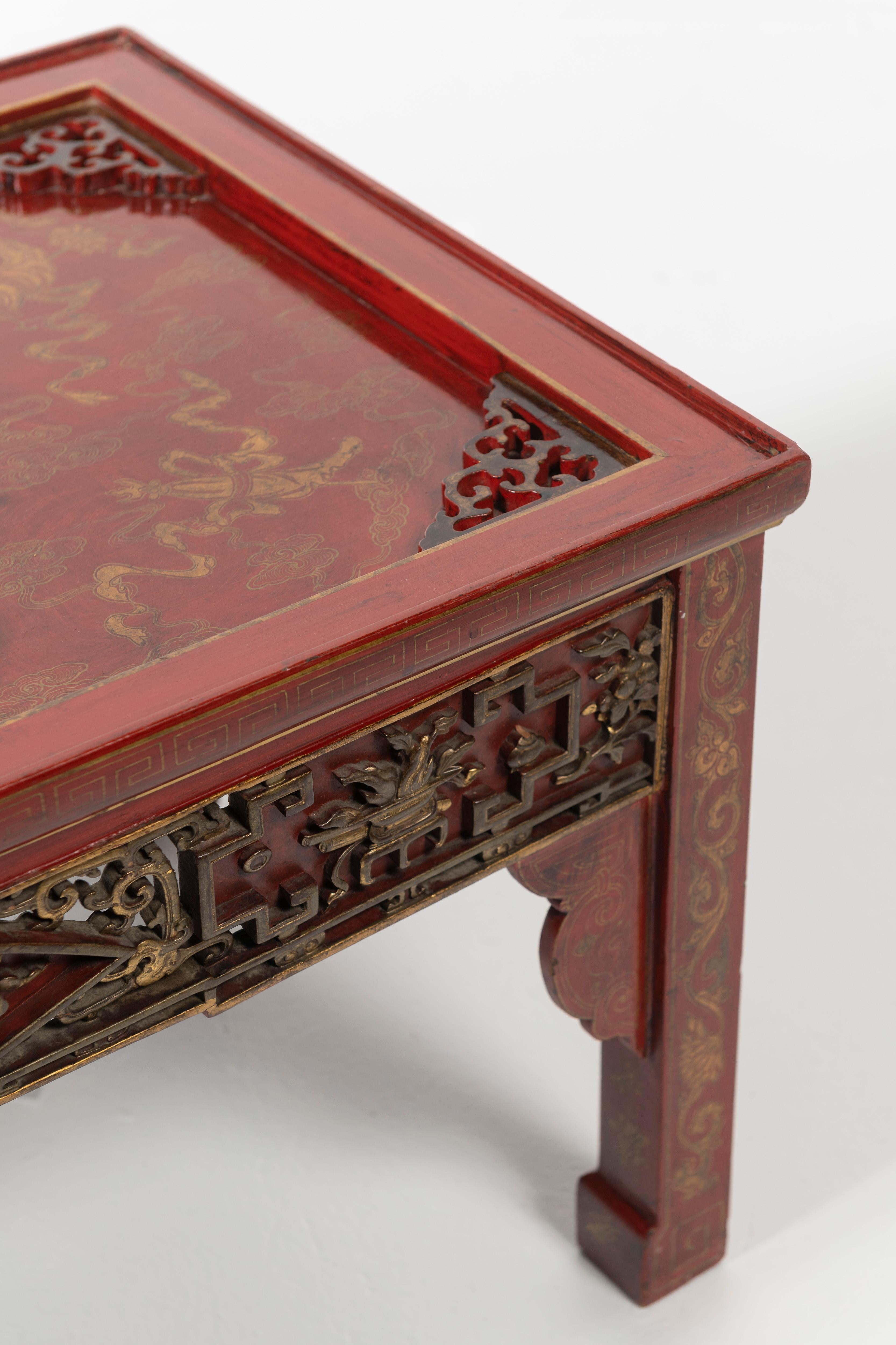 Unique red lacquered chinoiserie coffee table. Beautiful cravings and details, nice scale for most spaces.