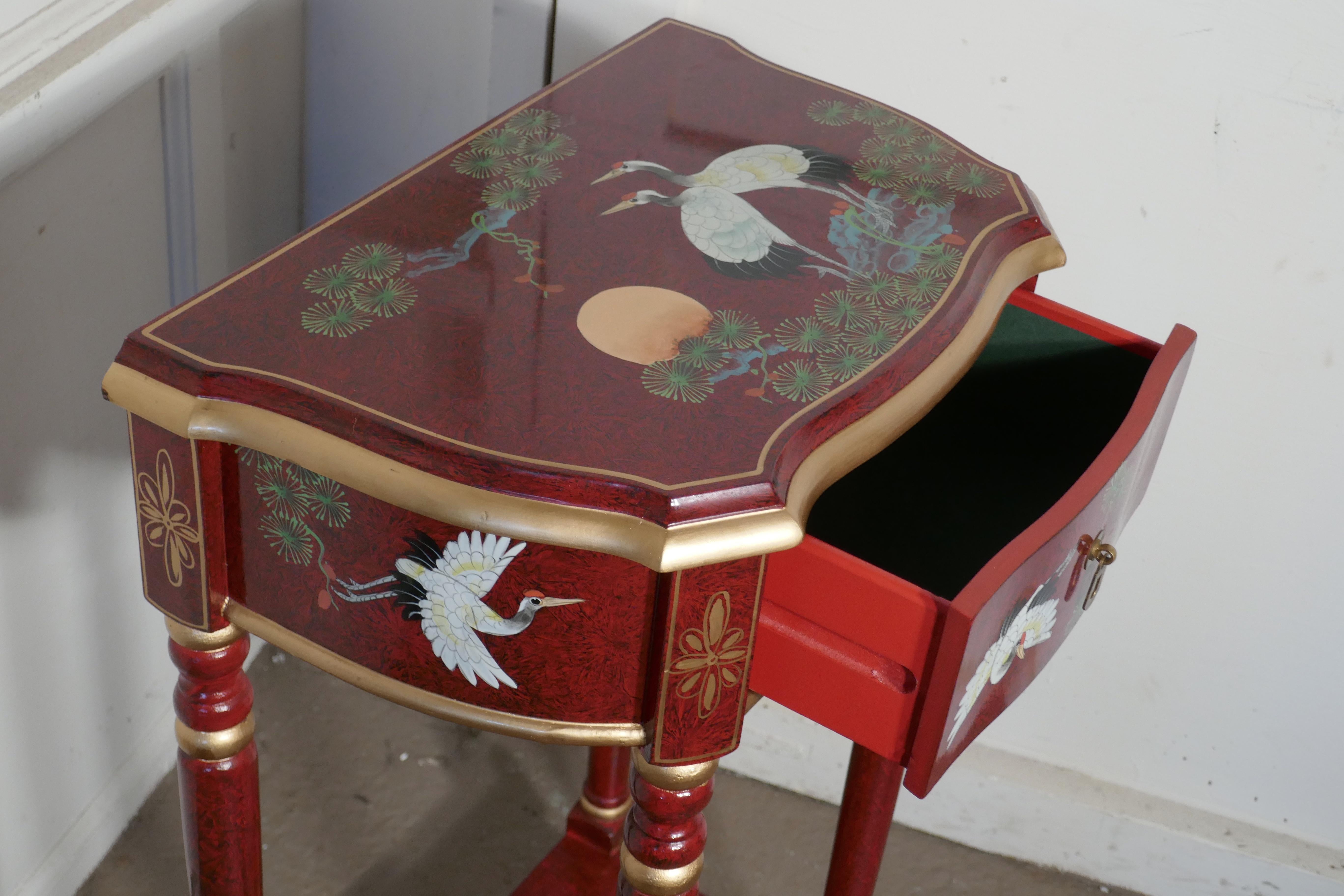 Red Lacquer Chinoiserie Side Table

This is a very auspicious piece, the top of the table has a scene showing 2 Cranes (birds of life) and the Red Rising Sun
It is a tall side table with an under tier and drawer decorated with japanned