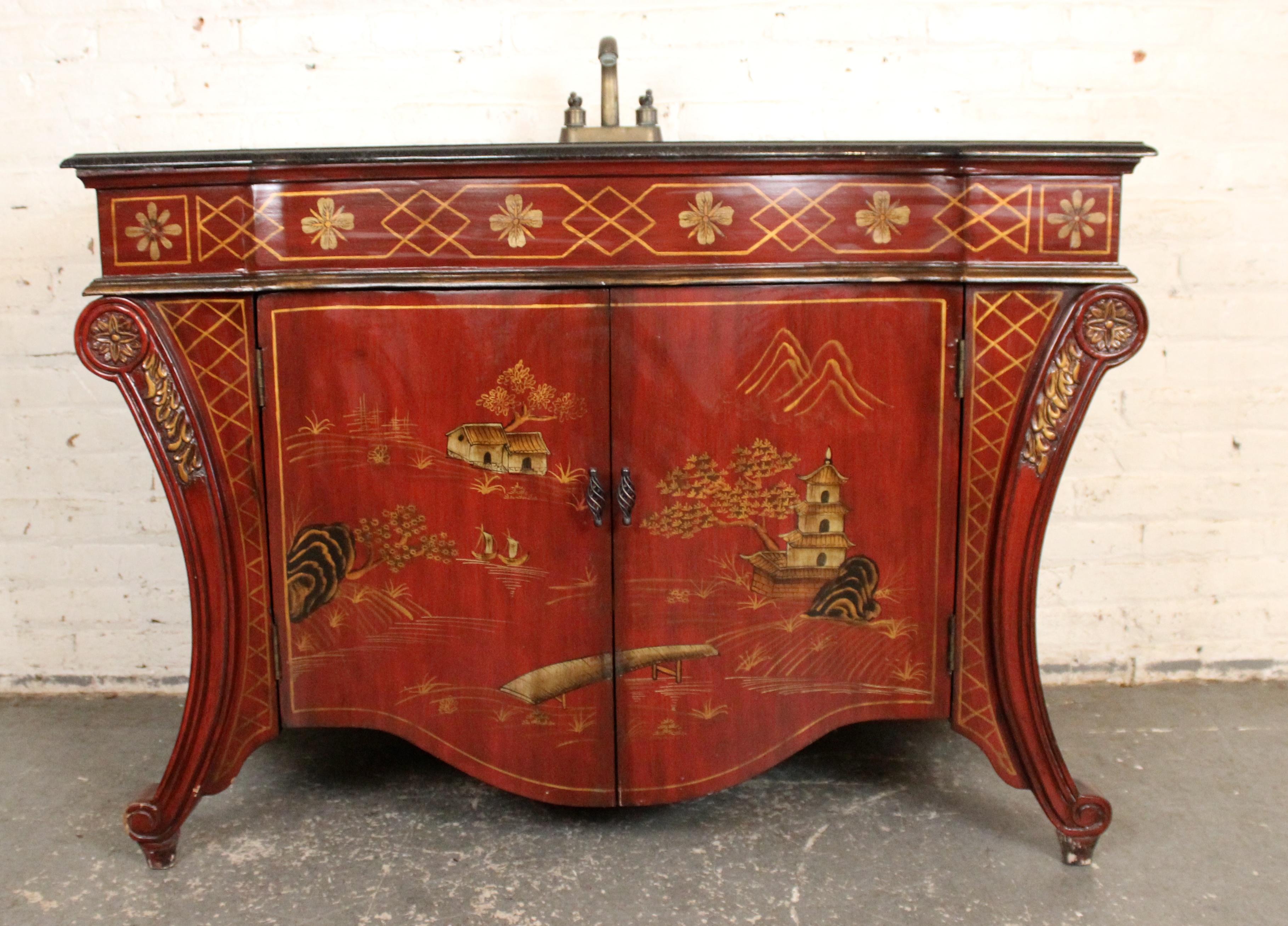 Elegant and unique red lacquer Chinoiserie sink featuring hand-painted gilt detailing and traditional Asian motifs. This decorative basin combines function with striking artistry, making it a bold focal point for a powder room or eclectic