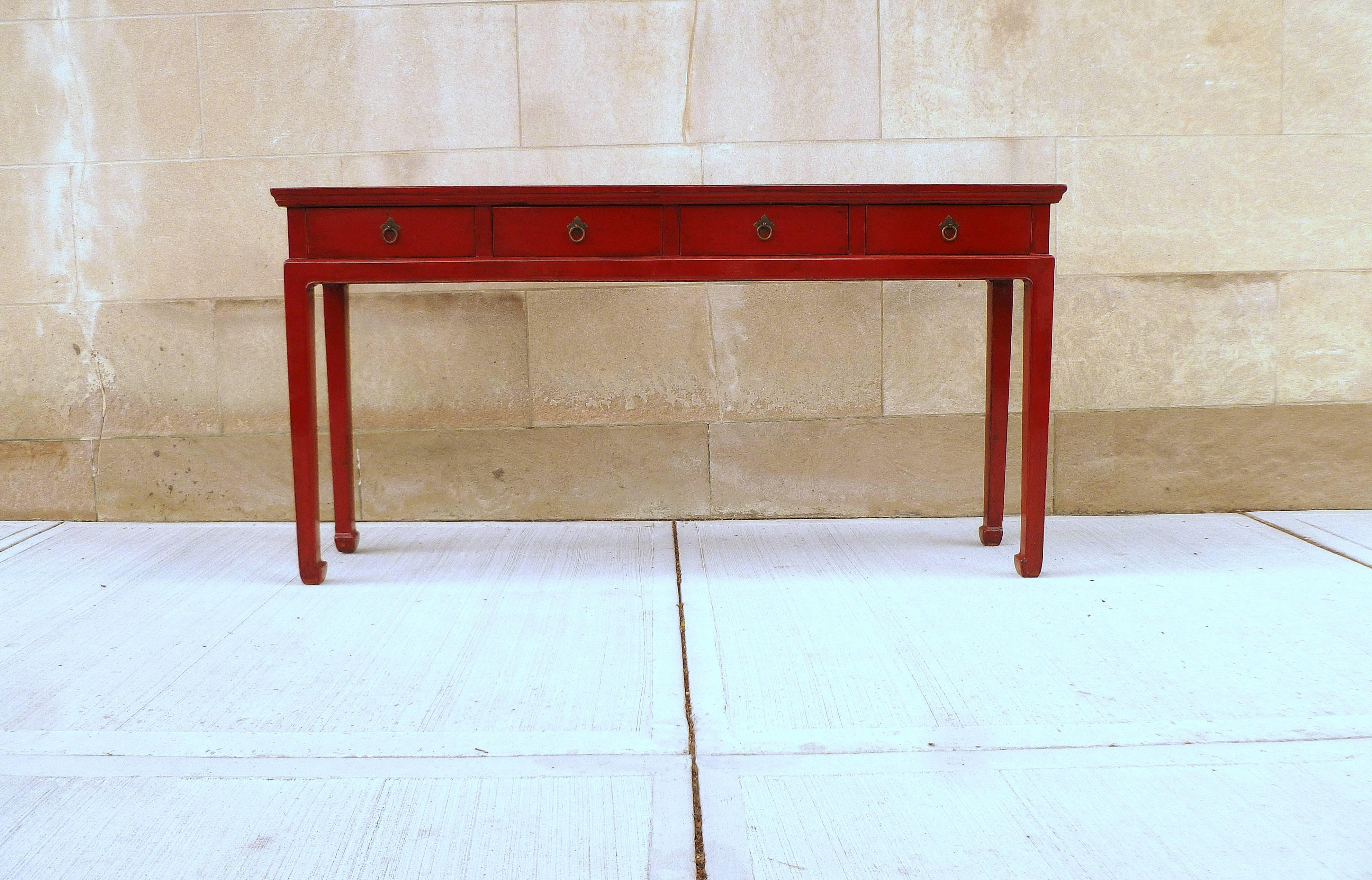 An elegant red lacquer console table with four drawers and brass fitting. We carry fine quality furniture with elegant finished and has been appeared many times in 