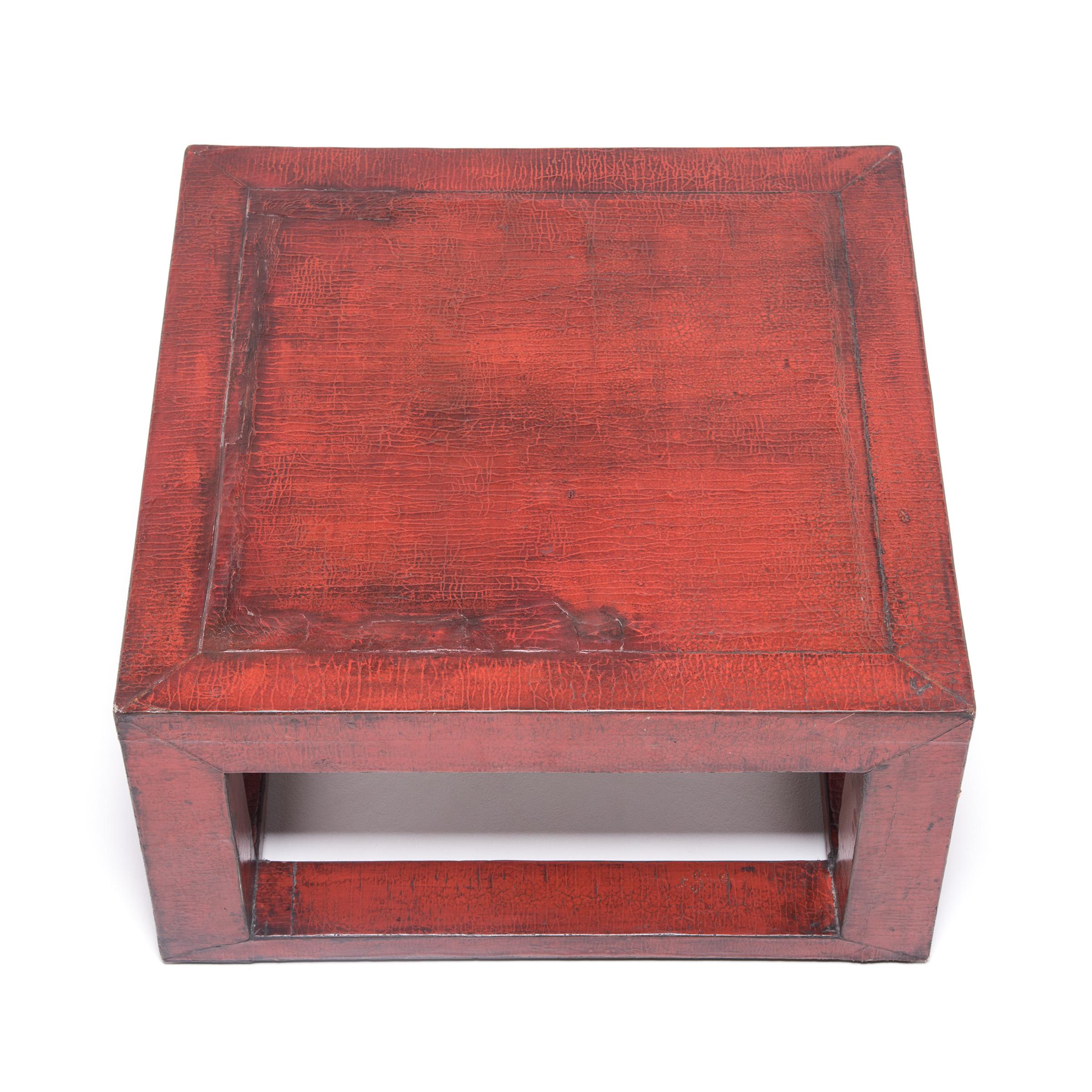 Fashioned with an open platform design, this square table made in Beijing recreates the look of aged red lacquer with an extravagant crackle finish. We love the way this low table pays tribute to the past, with an eye towards contemporary design