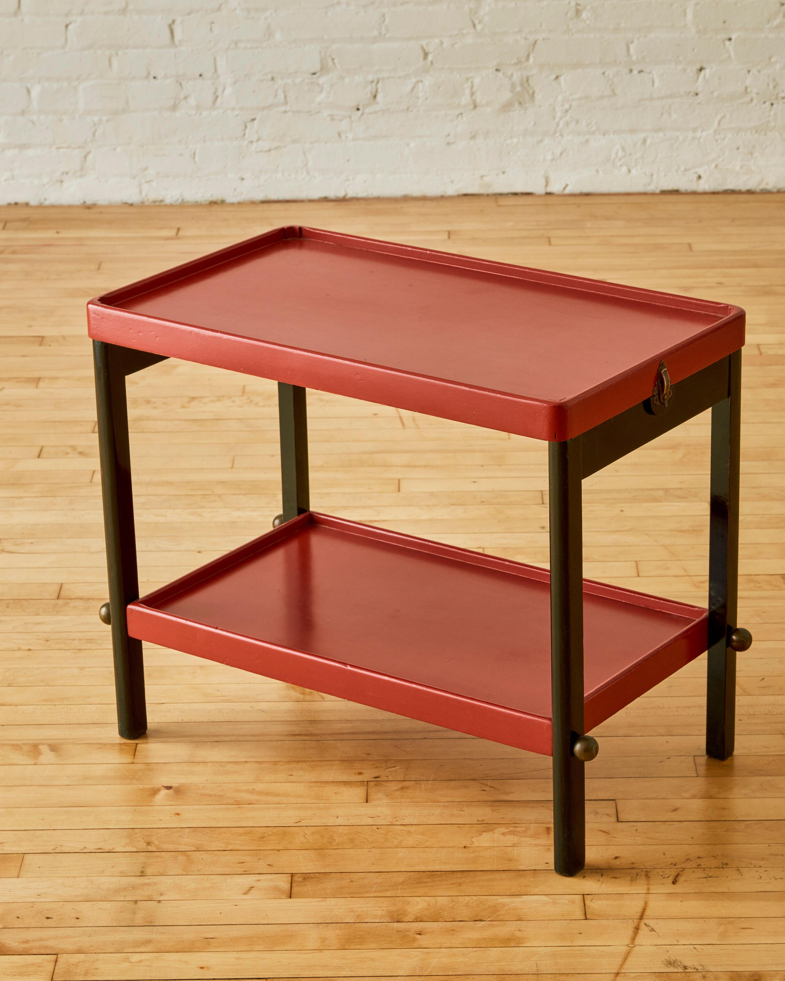 Red Lacquer Wood Side Table with bronze spherical details on the legs and latches that detach to reveal a removable tray top.

