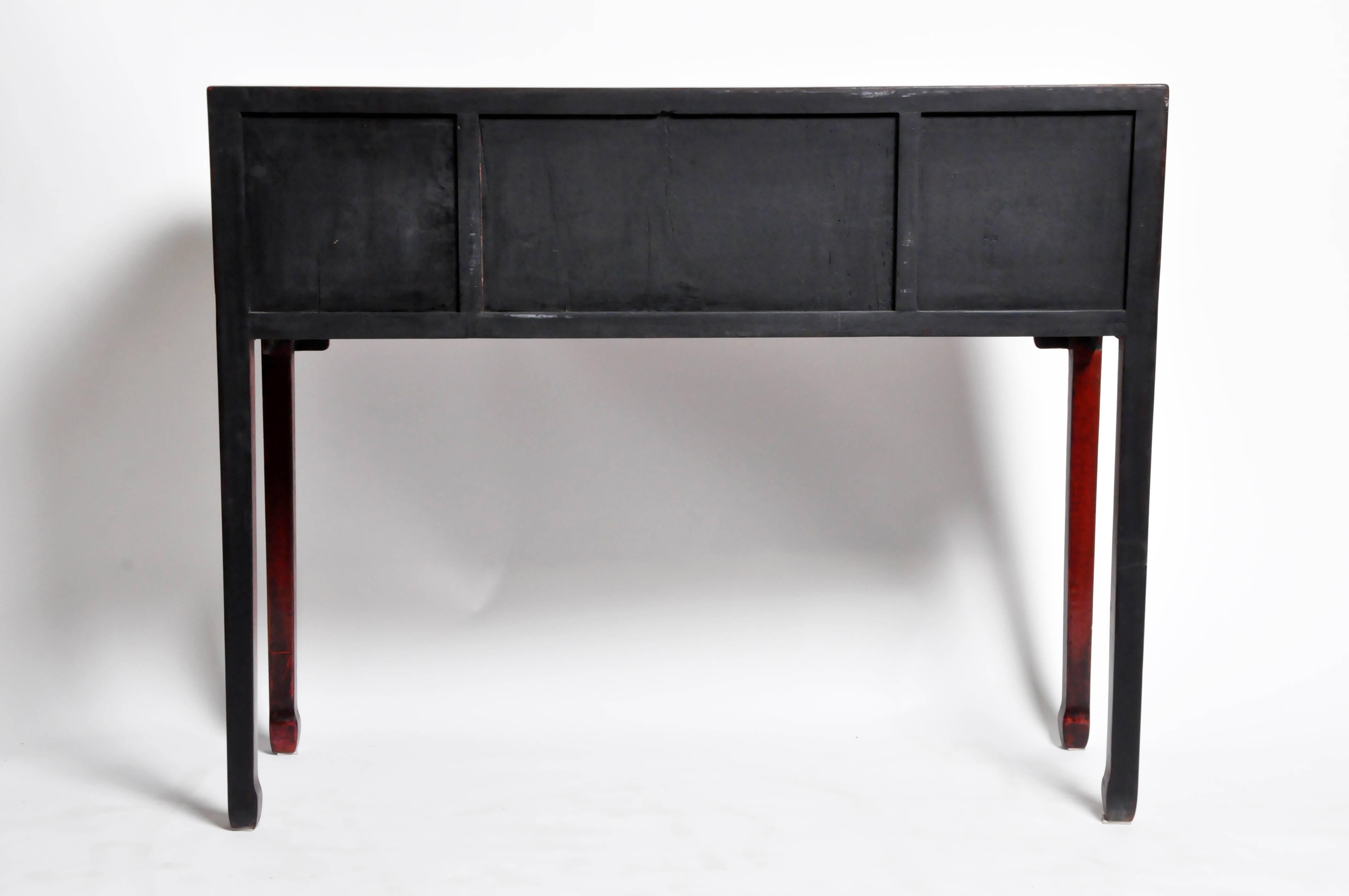 This console table is from Shandong, China and was made from reclaimed elm wood and red lacquer. The handsome piece features mortise and tenon joinery and four drawers. You can also customize a new one and make it your own. Wood, color, finish, and