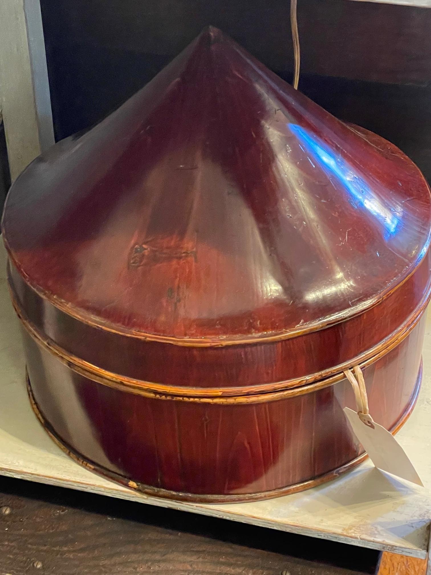 Heavily lacquered Chinese hat box with bold red surface. Great silhouette.