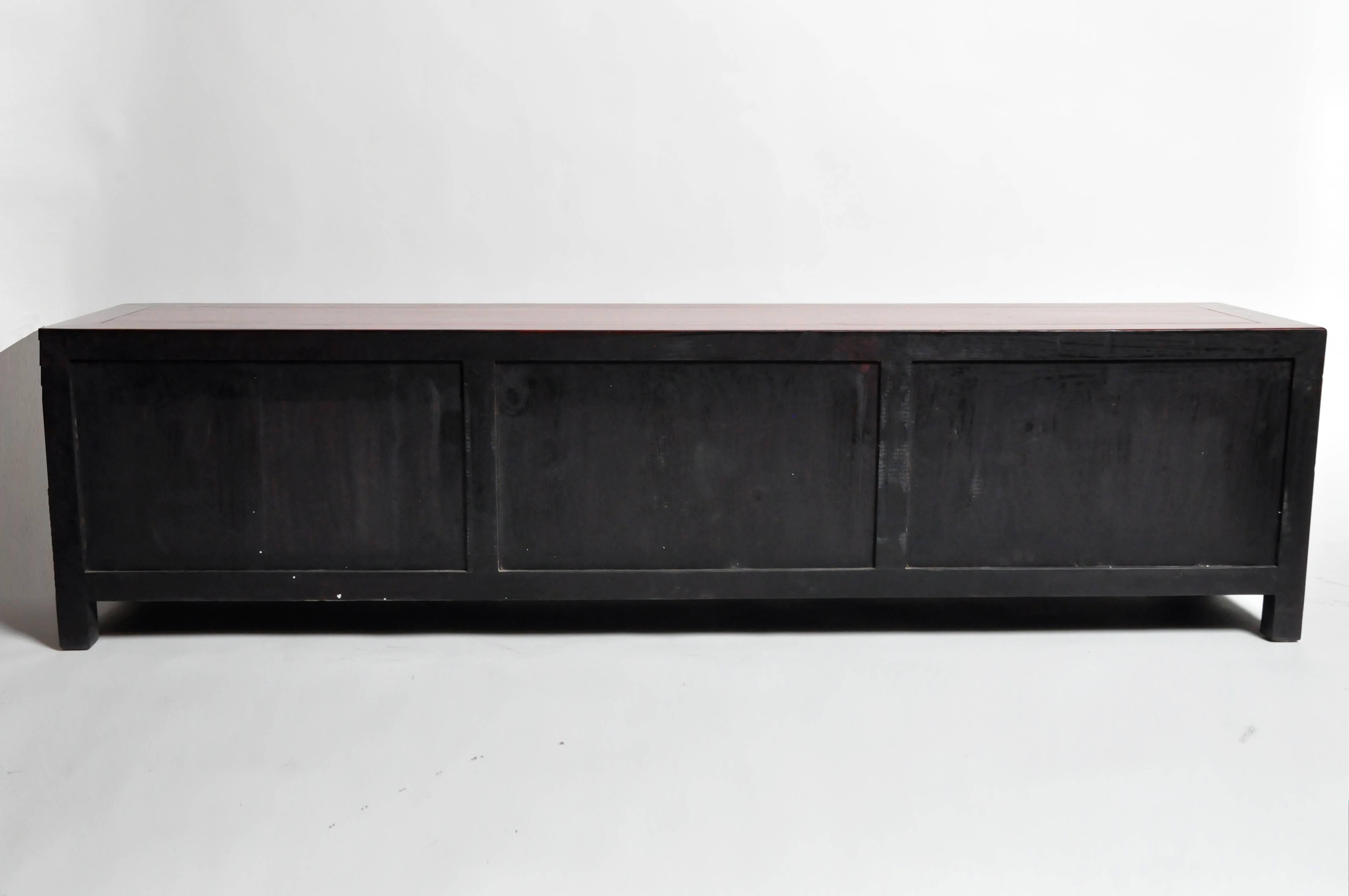 This handsome low chest is from Shandong, China and was made from reclaimed elm wood. The piece features mortise and tenon joinery, red lacquer and three shelves for storage. You can also customize it and make it your own. Wood, color, finish, and