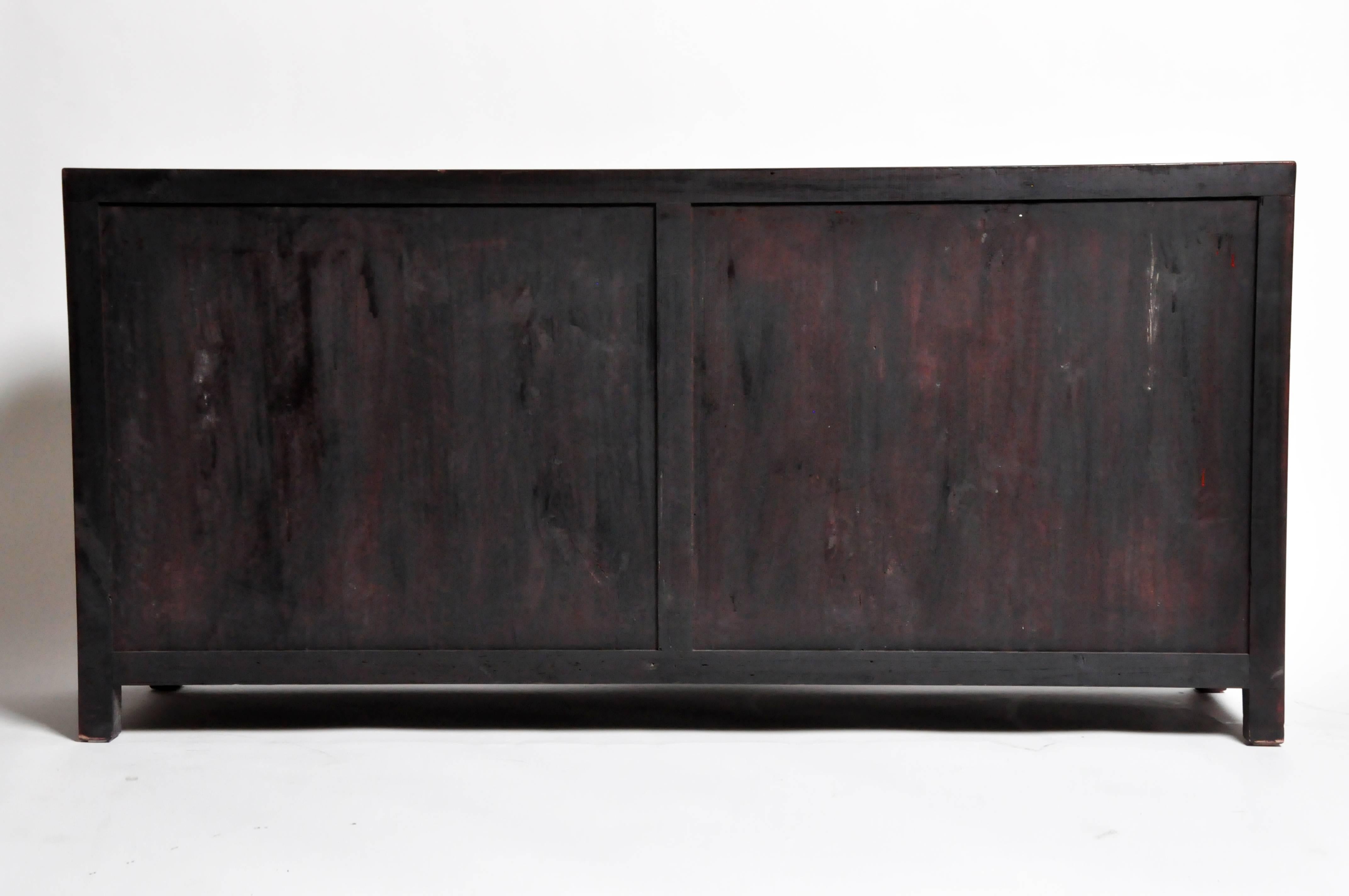 This sideboard is from Jiangsu, China and was made from reclaimed elm wood. The piece features mortise and tenon joinery, bi-folding doors, four drawers, and a shelves below for ample storage. You can also customize a new one and make it your own.