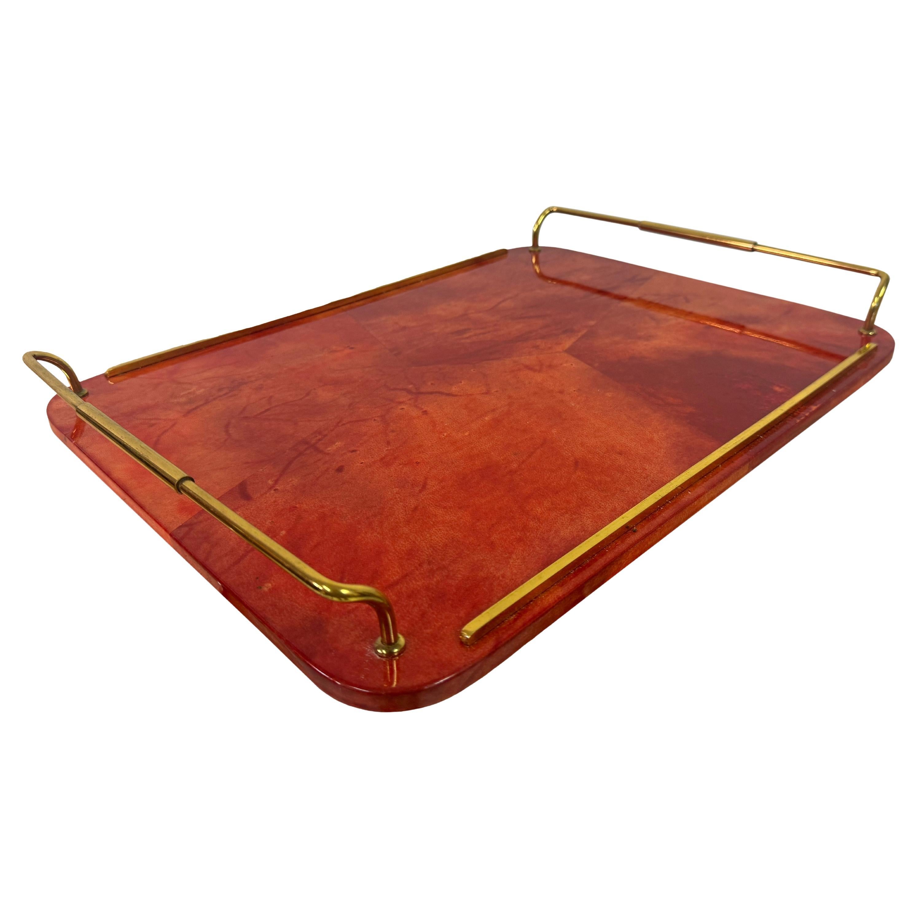 Tray

By Aldo Tura

Red

Lacquered goatskin

Brass handles

1960s Italy

This striking tray, designed by renowned Italian designer Aldo Tura, epitomizes the luxurious and distinctive style of the 1960s. The tray's surface is meticulously crafted