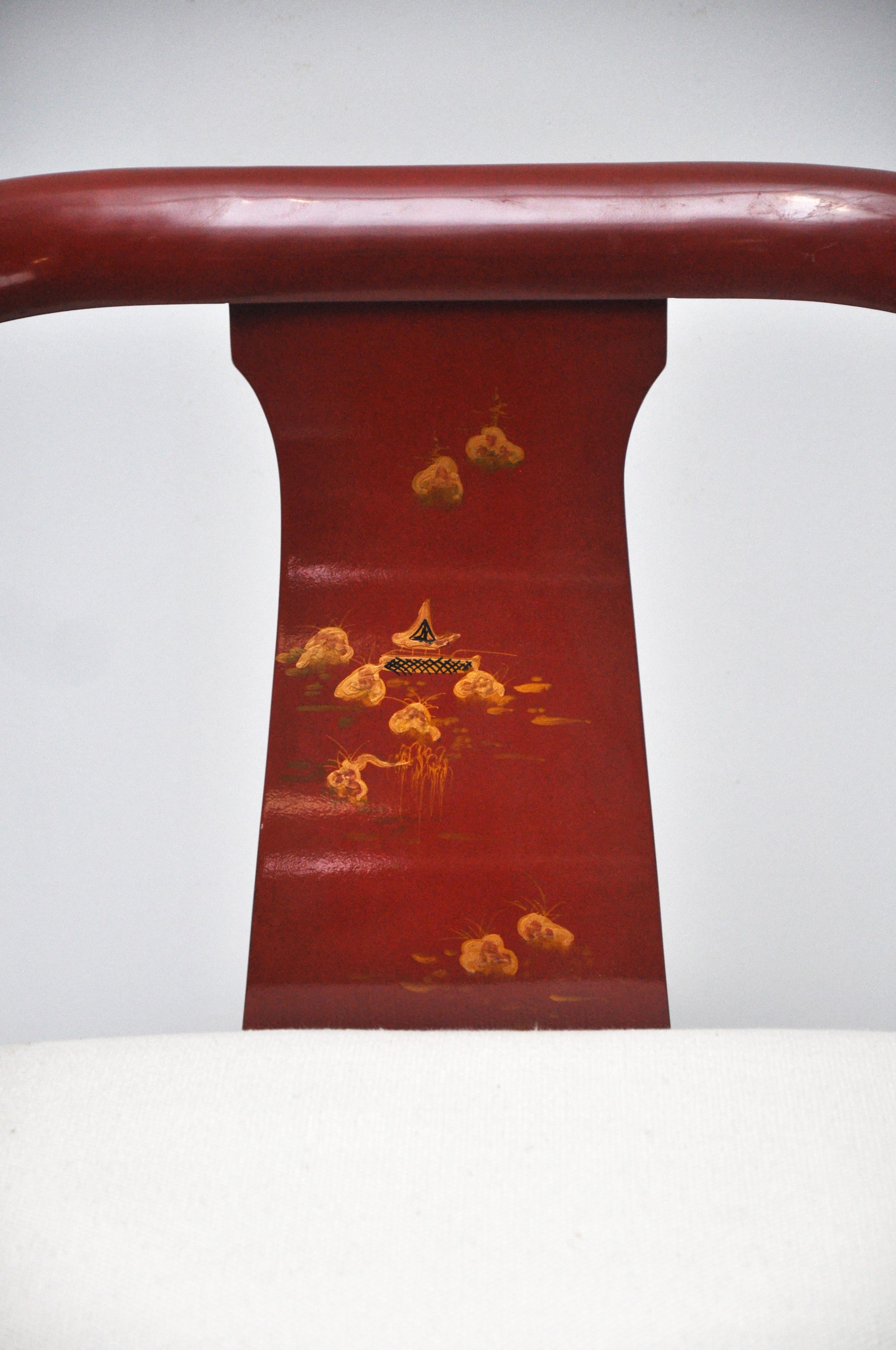 Chinoiserie style Chinese red lacquer horseshoe club chair. Chair has brass detailing. This Ming style chair has a hand painted scene on both the front and back. Seat height is 17