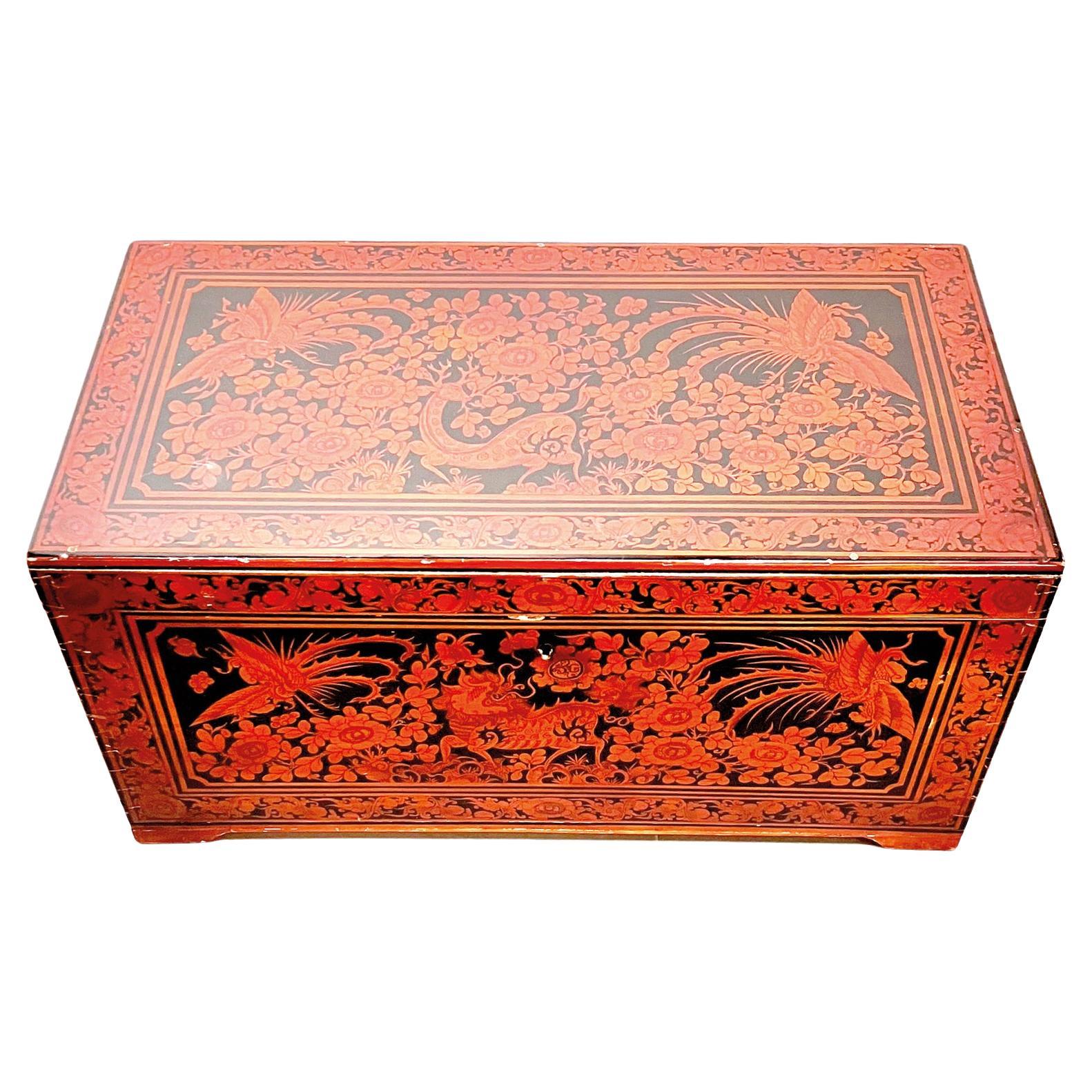 A trunk of substantial size and style. The interior hosts a large main compartment with a section which sits on top with smaller compartments. ideal for small item storage. 
The exterior has beautifully ornate, hand painted red lacquered detailing.
