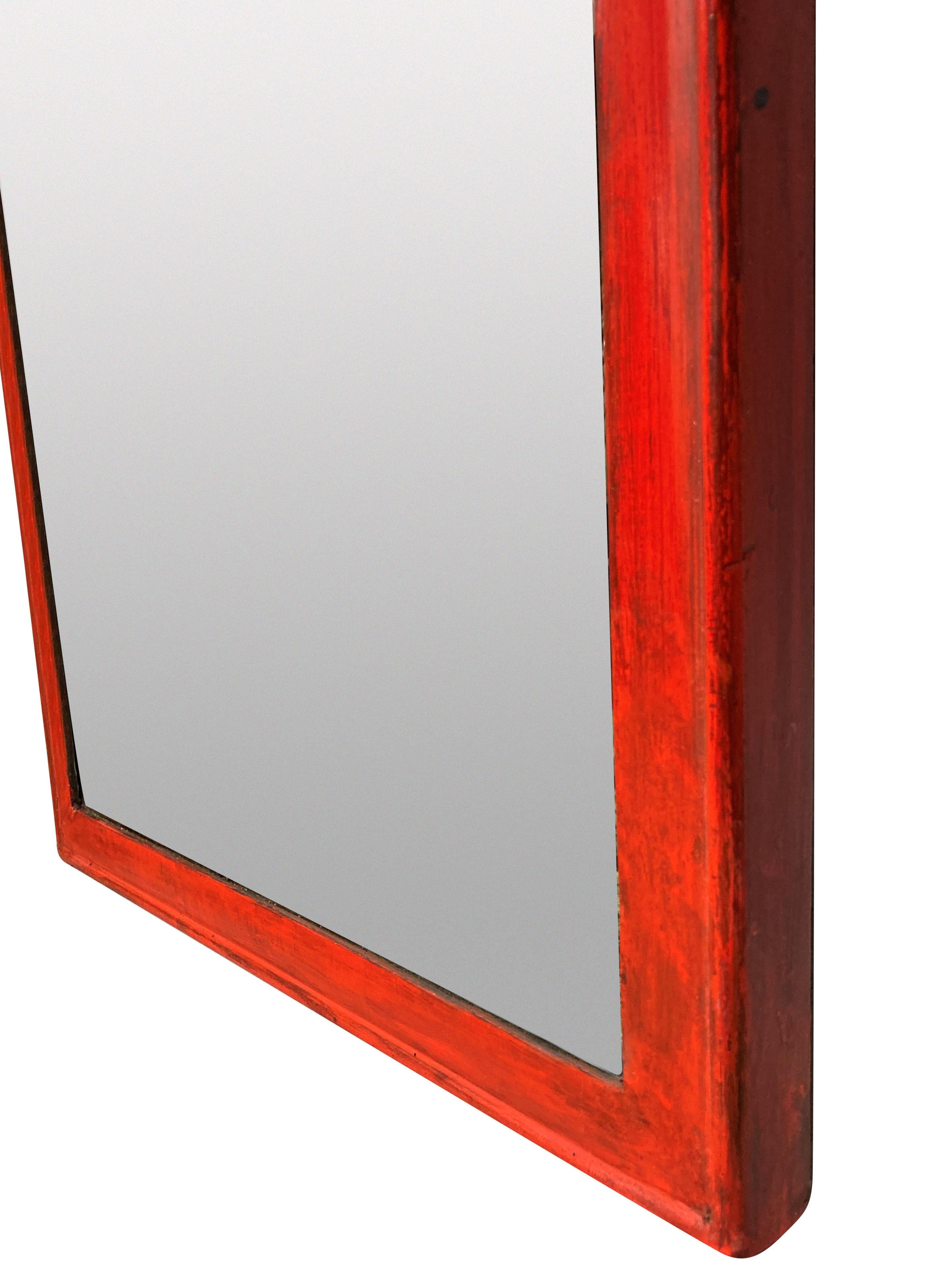 An English Queen Anne style red lacquered slender mirror, which makes up a matched pair with a seperate listing.
