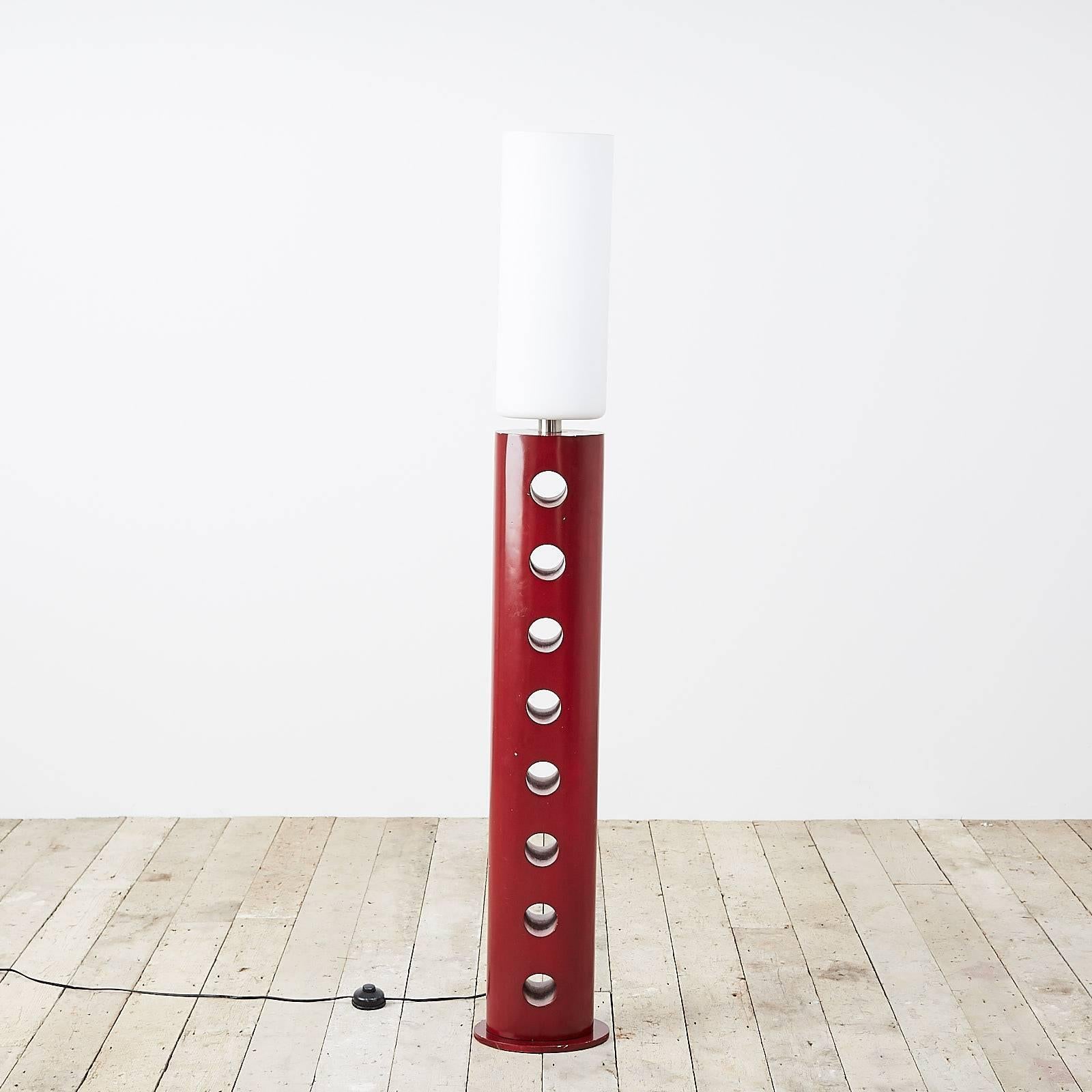 A red lacquered standard lamp with perforated base and tall opaline shade, Italian, 1980s.