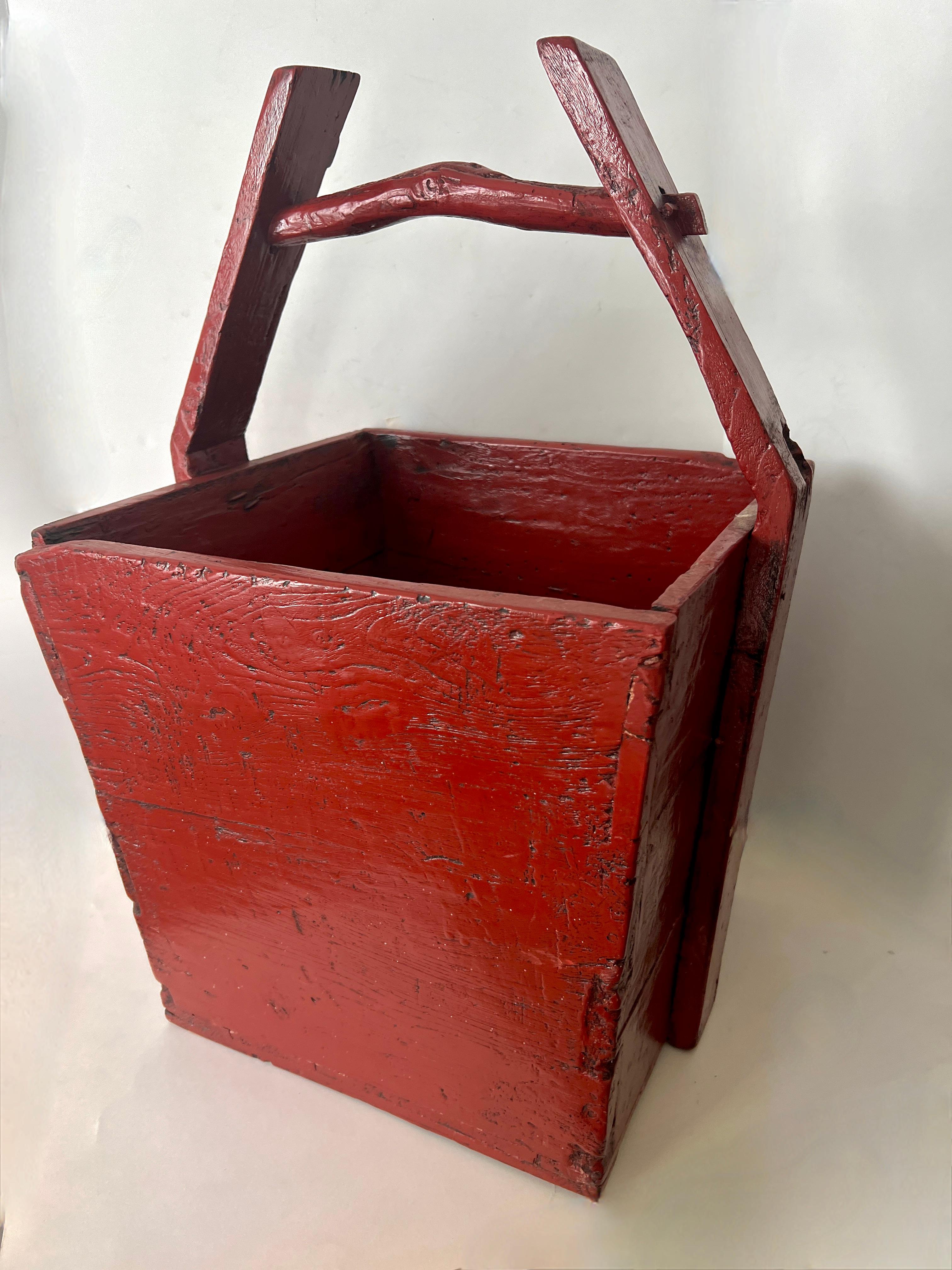 A Wooden and very beautiful Antique Rice Carrier that it lacquered in red.

The piece is a compliment to many settings and spaces.  This could be used as a planter, centerpiece, under a console, in a bathroom holding towels or next to the fireplace