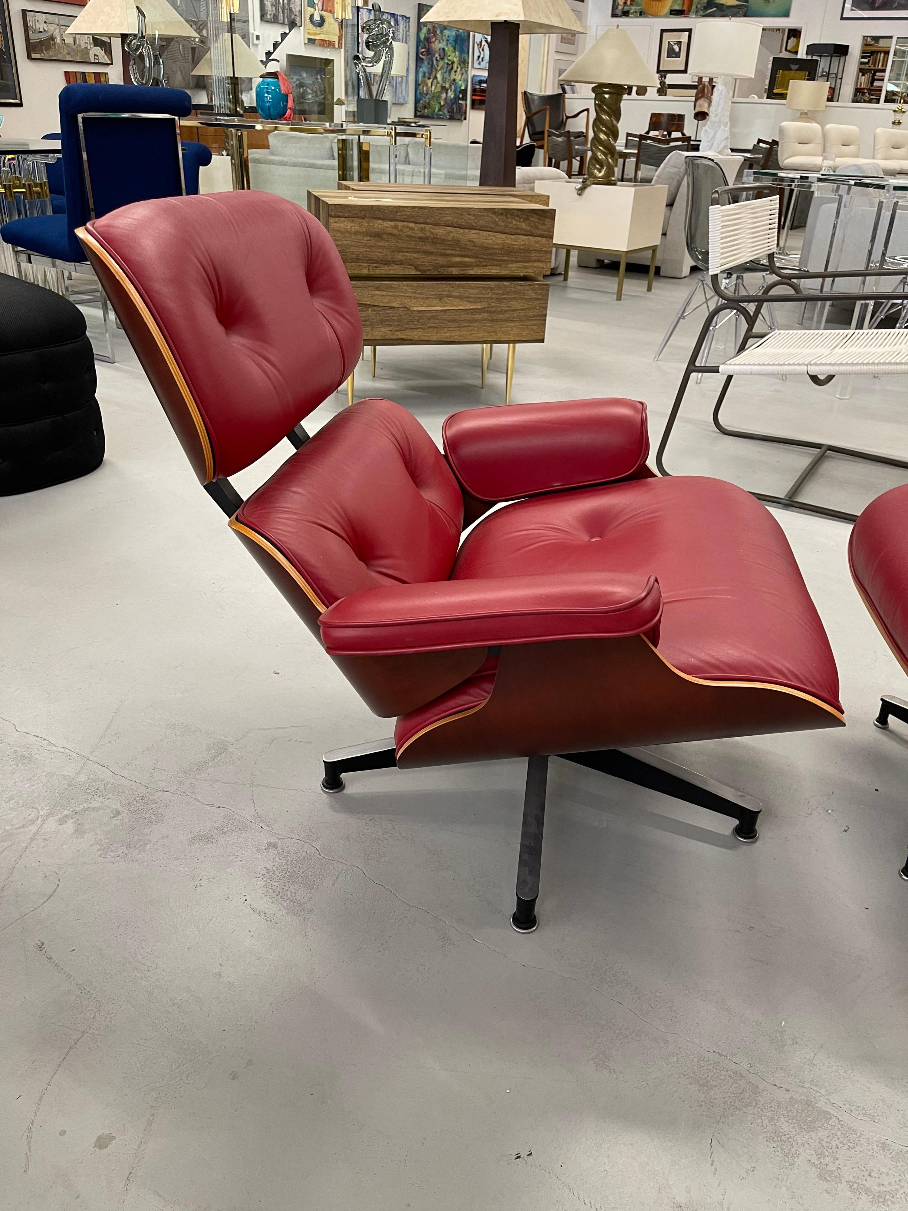 A clean red leather Eames chair and ottoman from the estate of the novelist Judith Krantz. It has the Herman Miller Tags and a production label from 9/30/2005. The shell is Cherry I believe. Leather is in excellent condition. A few flecks of paint