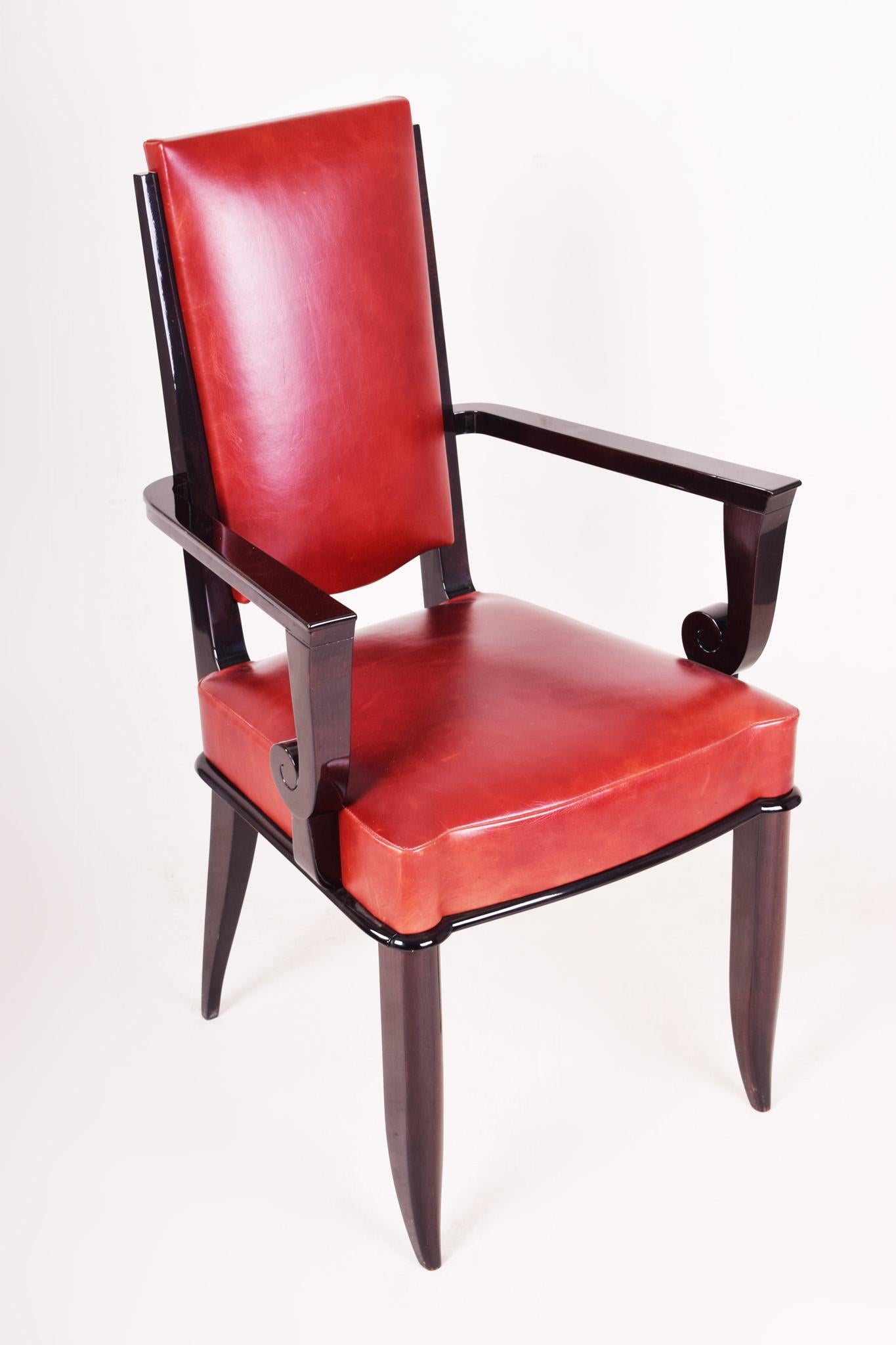 French Art Deco armchair.
Designed: Jules Leleu
Completely restored, surface made by piano lacquers to the high gloss. New upholstery in red leather. 
Material: Macassar ebony veneer.
  