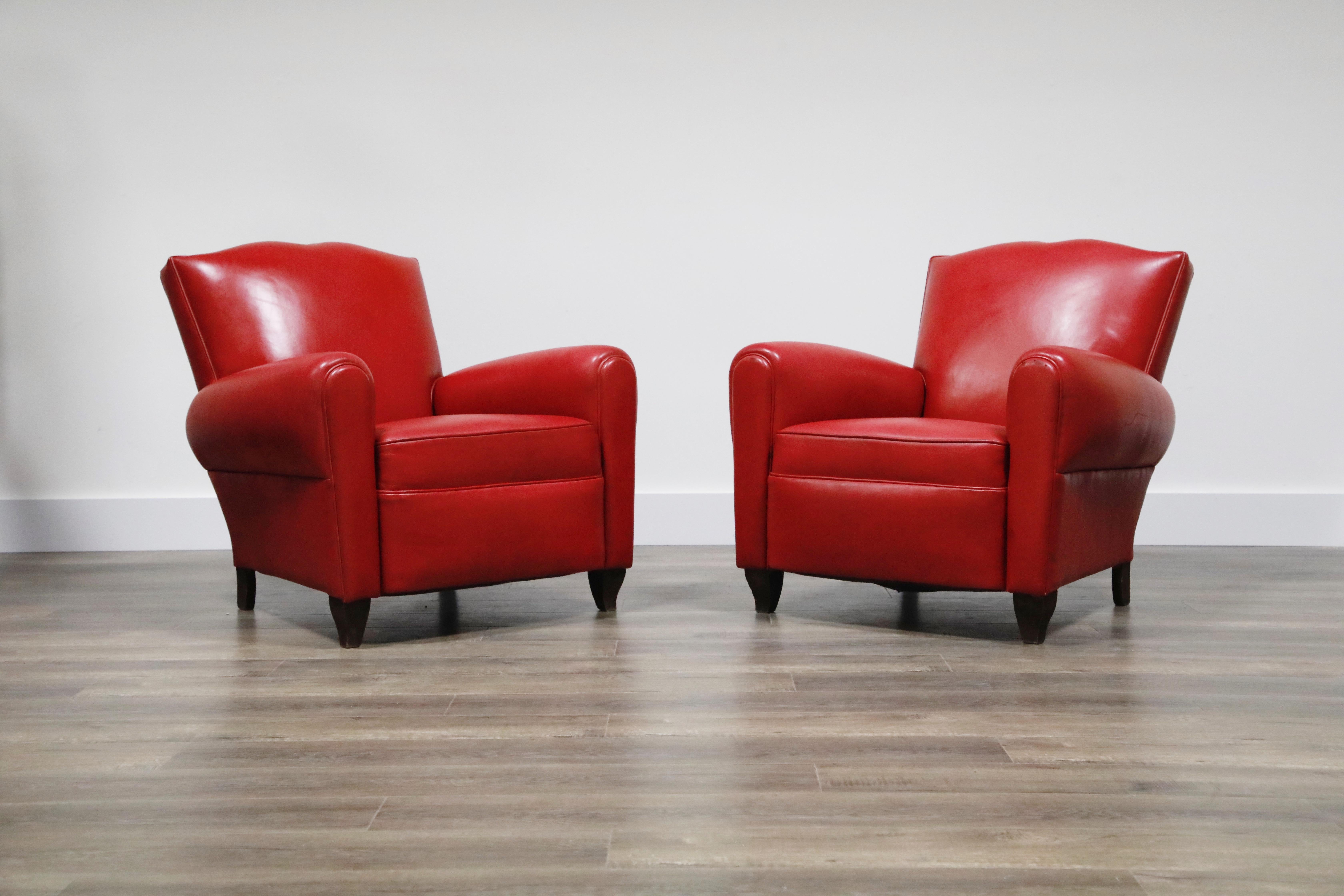 This Classic pair of Art Deco moustache club chairs were recently restored in a beautiful red leather and used in a light showroom setting with very light wear and light patina. In this deep red leather the shape also mimics lips with red lipstick.